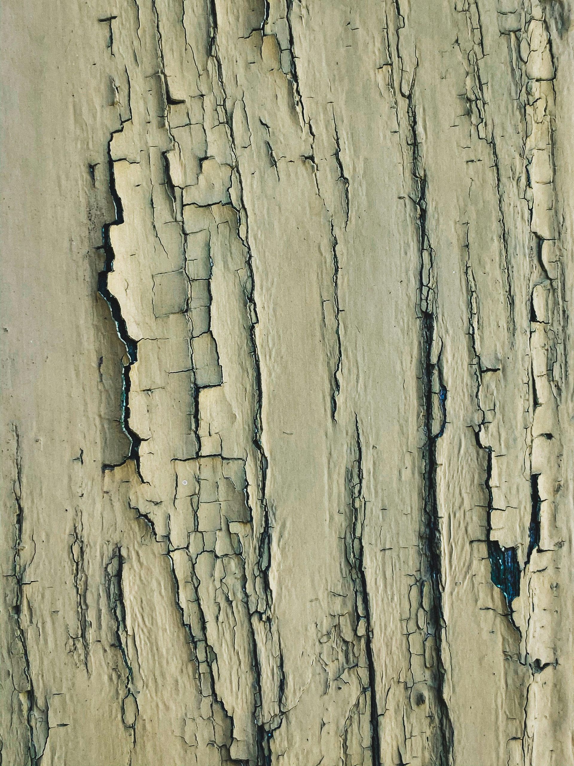 Worn pain on an old wooden surface.