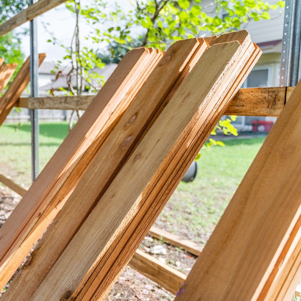 A bunch of wooden boards are stacked on top of each other.