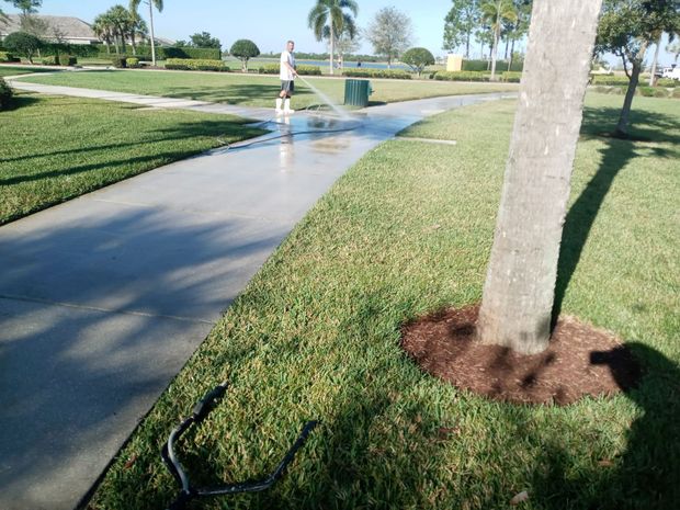 image of pressure washing services in Port St. Lucie.  You can see a sidewalk getting a pressure washing treatment.