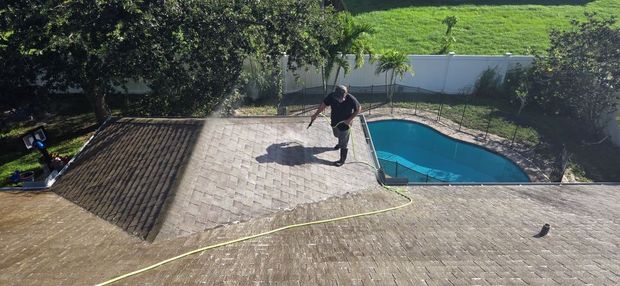 Image Showing RNR Pressure Cleaning soft washing a house roof. 