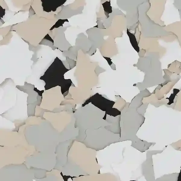 Scattered beige, gray, and white confetti-like paper pieces on a light background