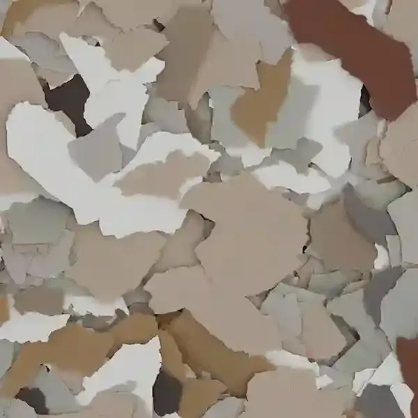 Scattered beige, white, and brown paint flakes on a flat surface
