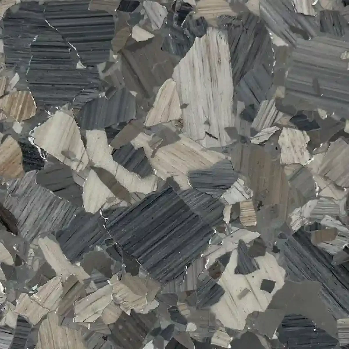 Abstract gray and beige patterned surface with layered, angular mosaic-like shards