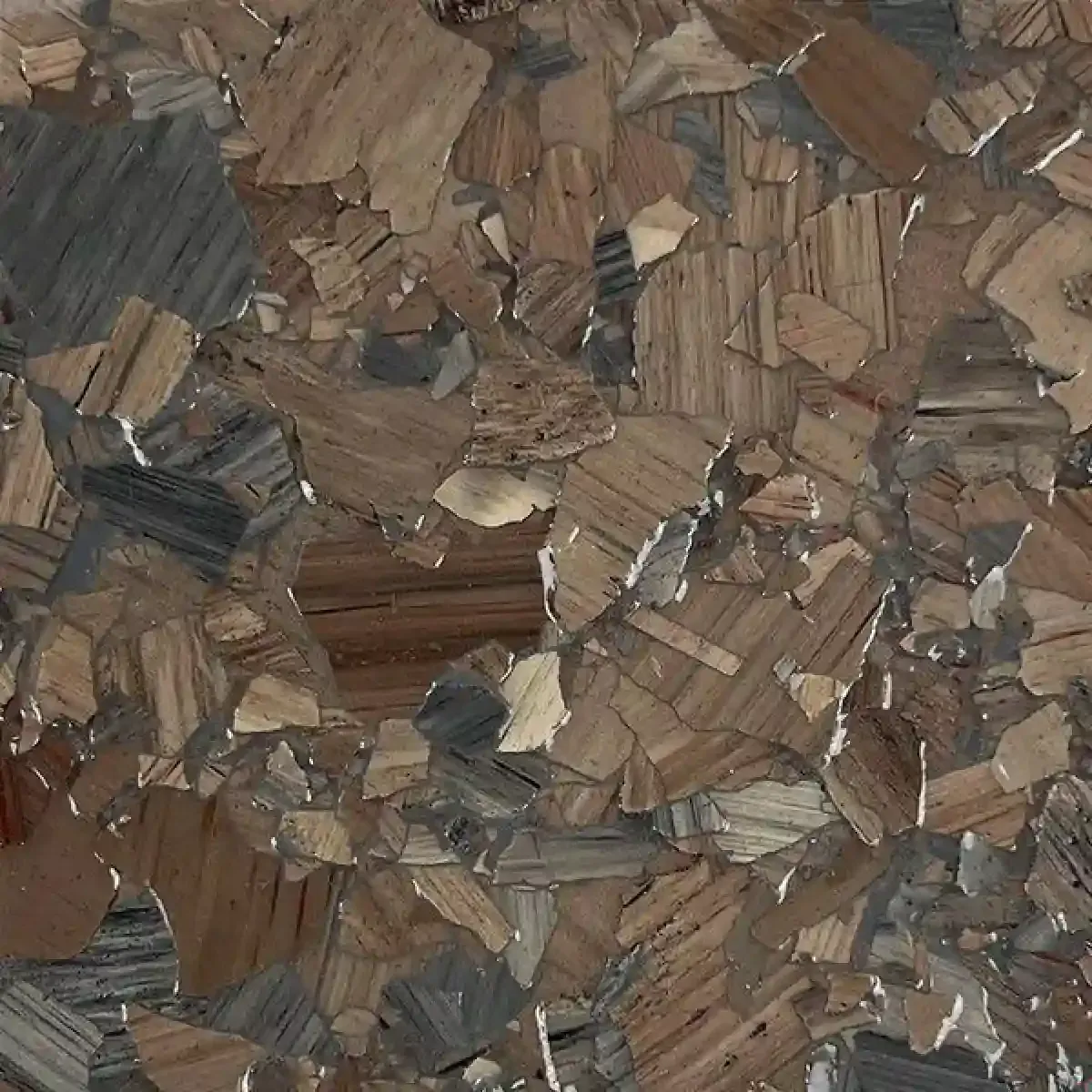 Close-up of a brown and gray wood-chip or bark mosaic texture