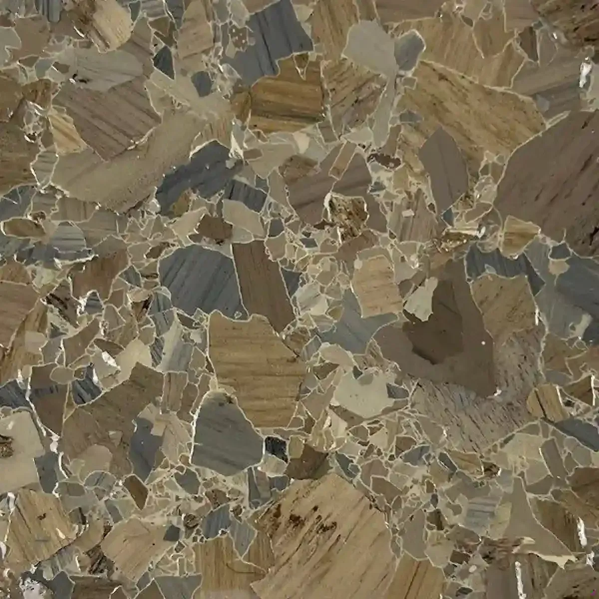 Close-up of tan and gray stone tiles with irregular geometric mosaic patterns.