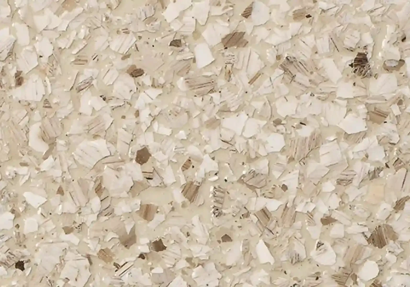 Close-up of beige rice grains filling the frame, showing a dry textured surface.