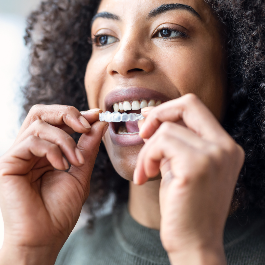 woman placing clear aligners