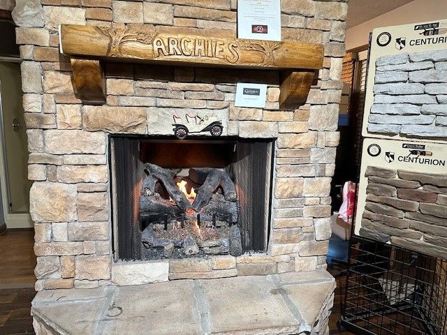A Living Room With A Brick Fireplace | Knoxville, TN | Archie's