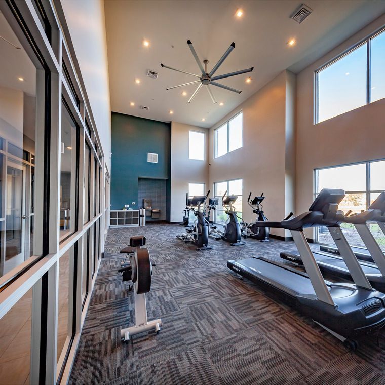 A large gym with treadmills and exercise bikes at Flats at Stones Crossing.