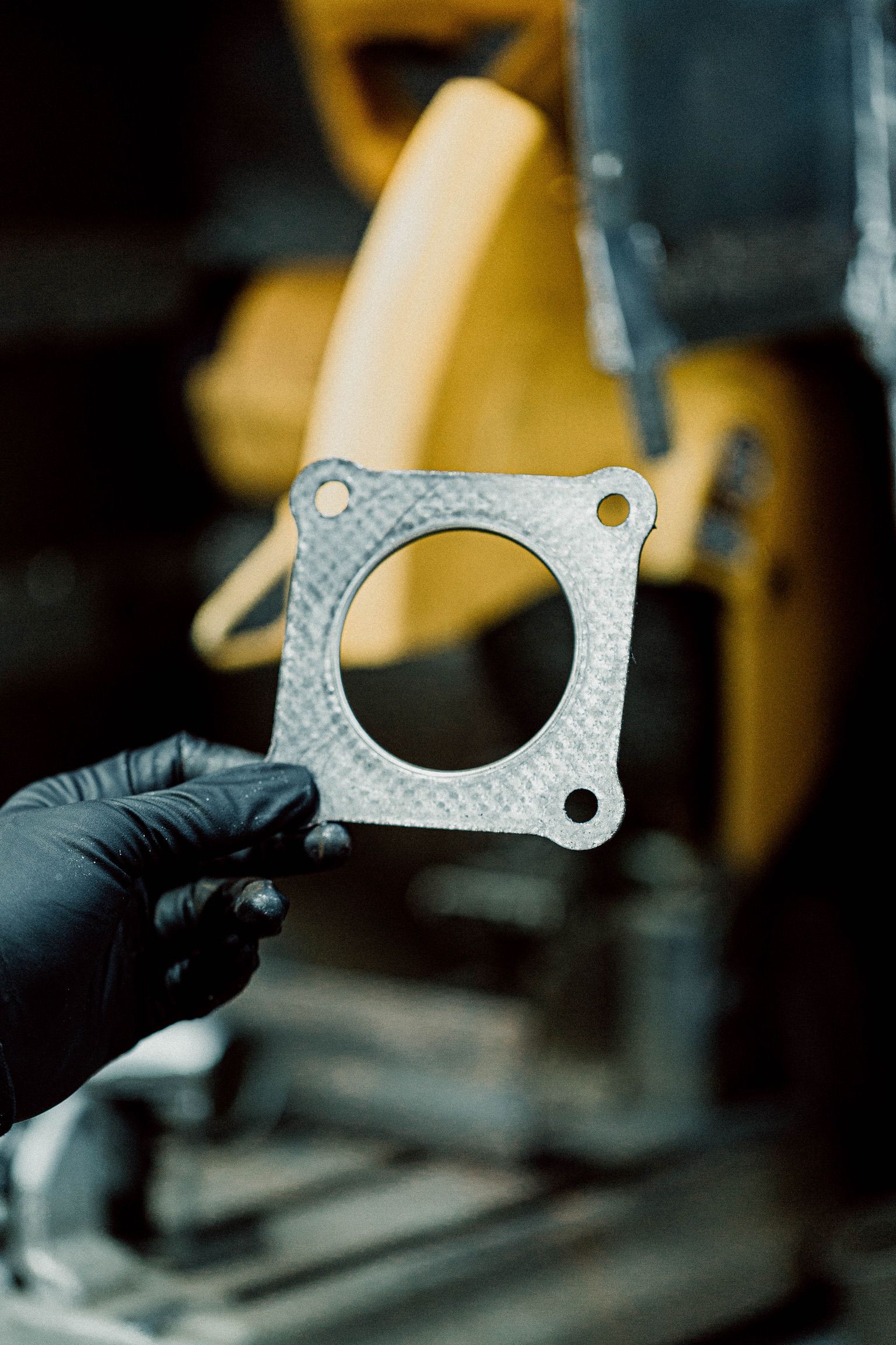 A person is holding a piece of metal in their hand.