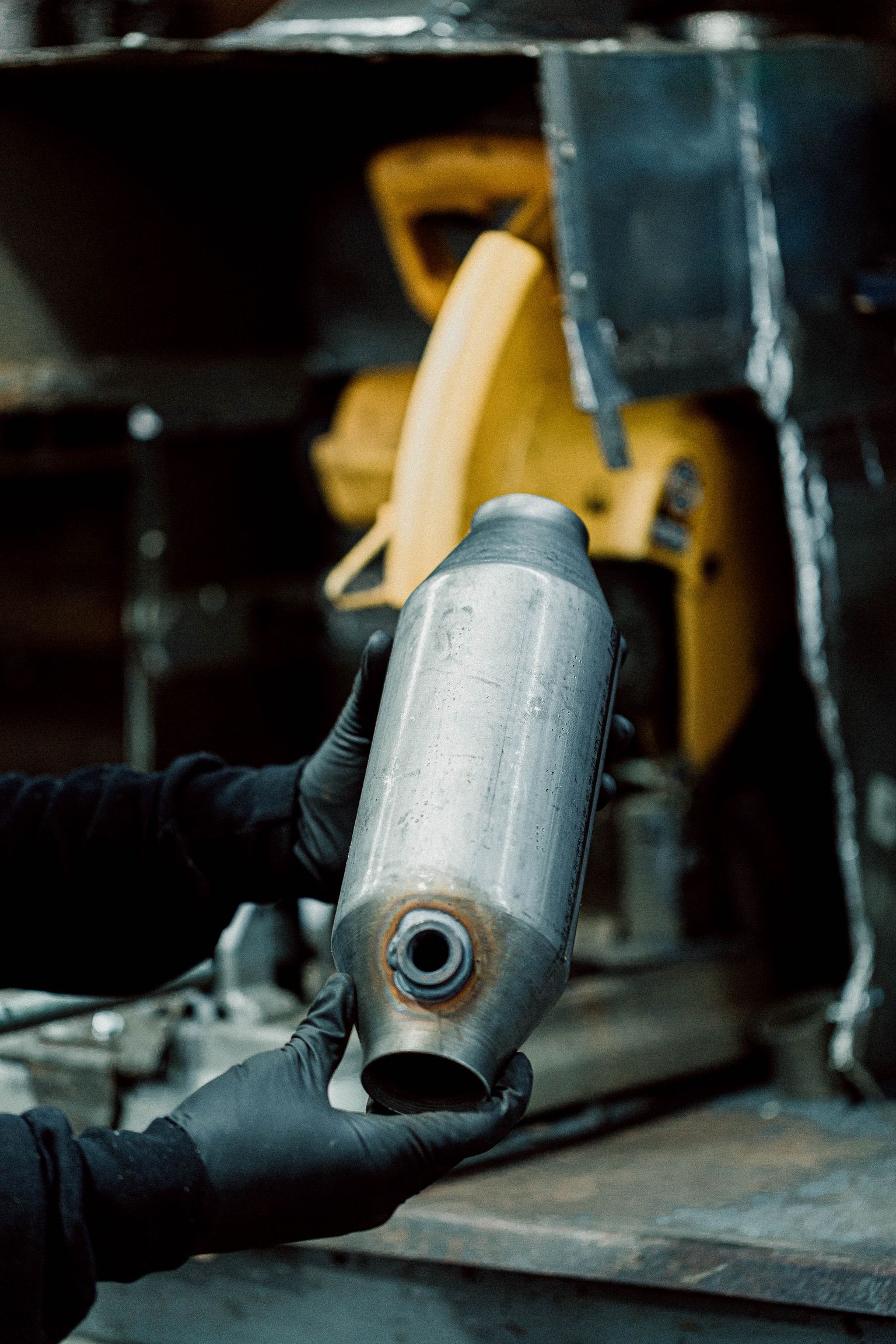 A person is holding a metal object in their hands.