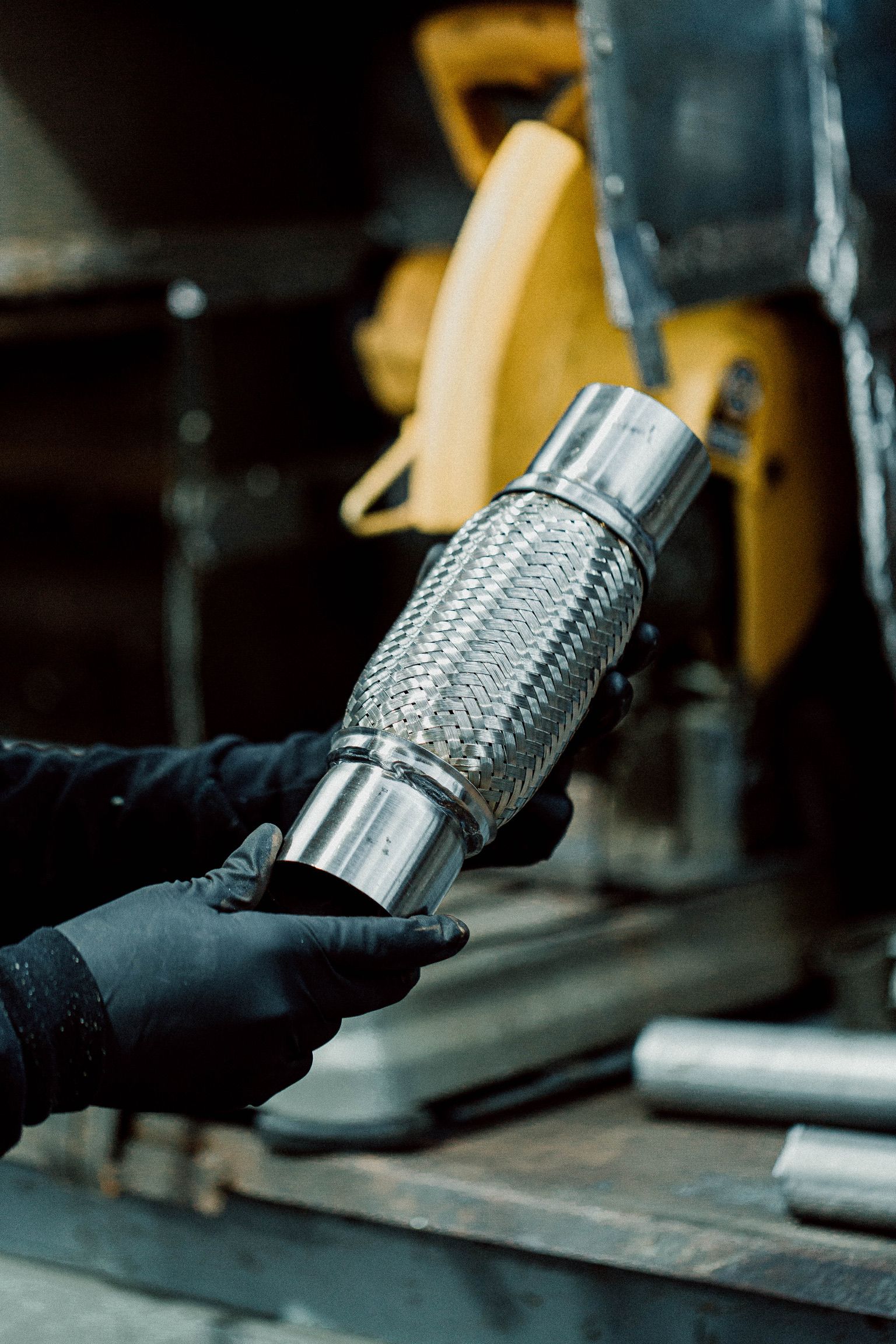 A person is holding a metal pipe in their hands.