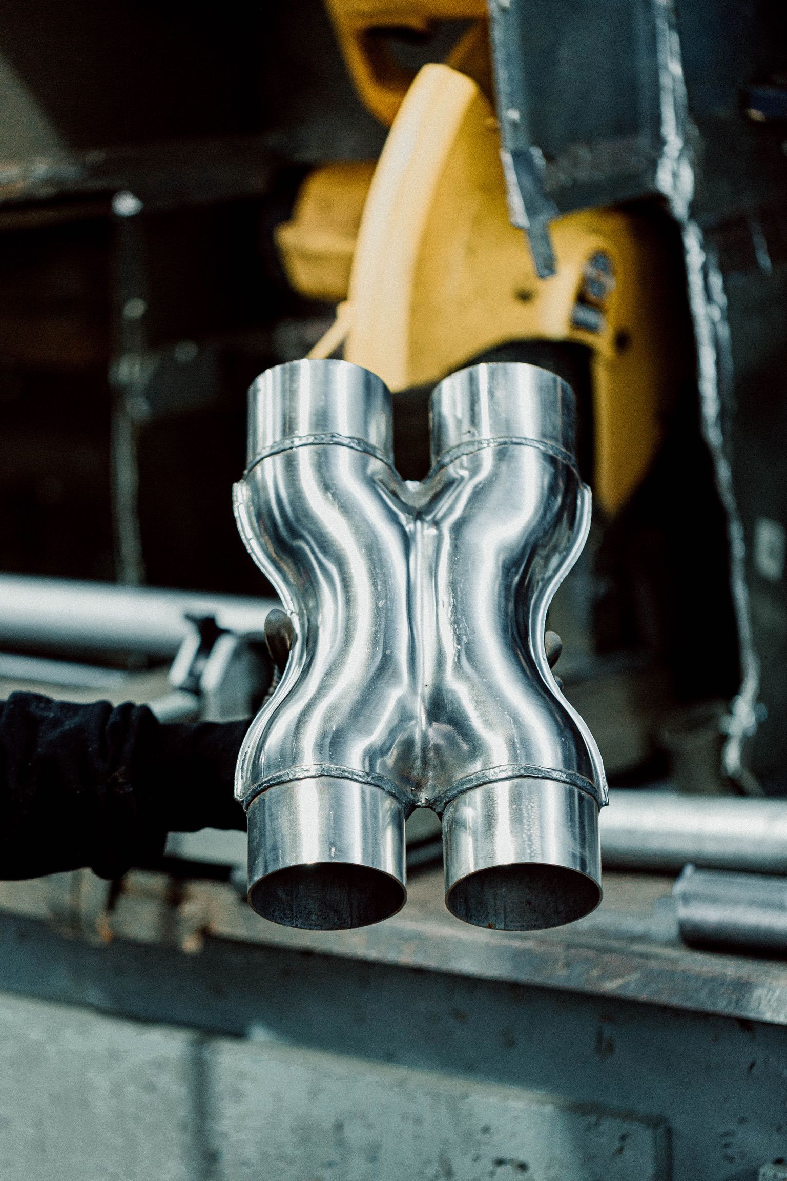 A close up of a metal pipe that looks like an x on a table.