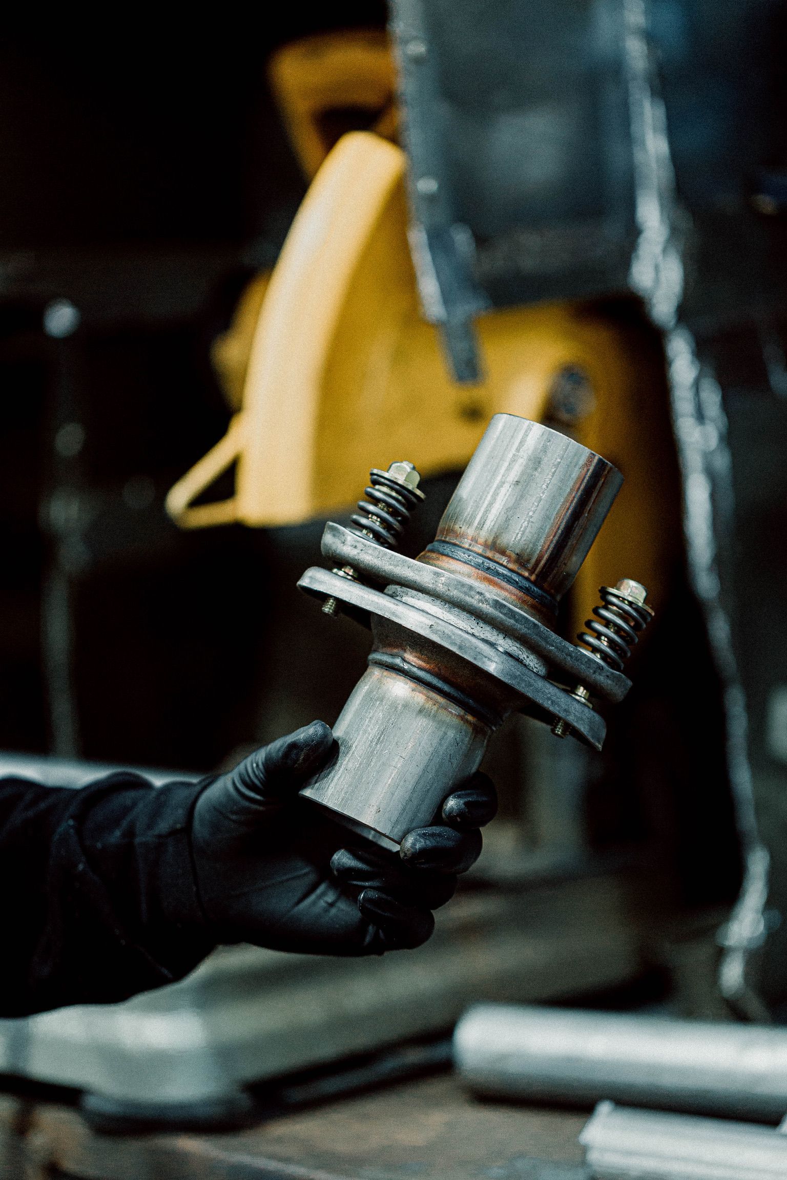 A person is holding a piece of metal in their hands.