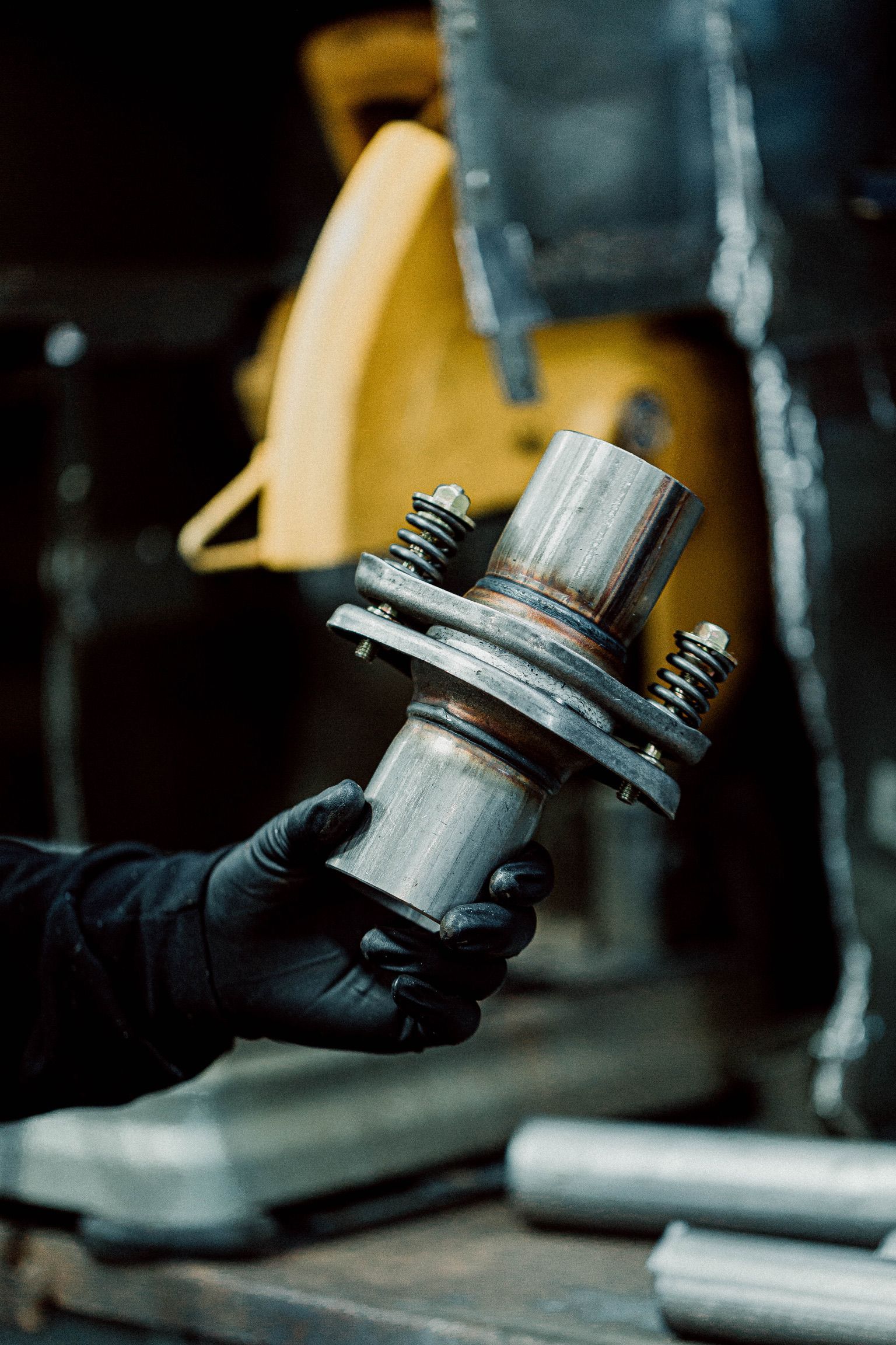 A person is holding a piece of metal in their hand.
