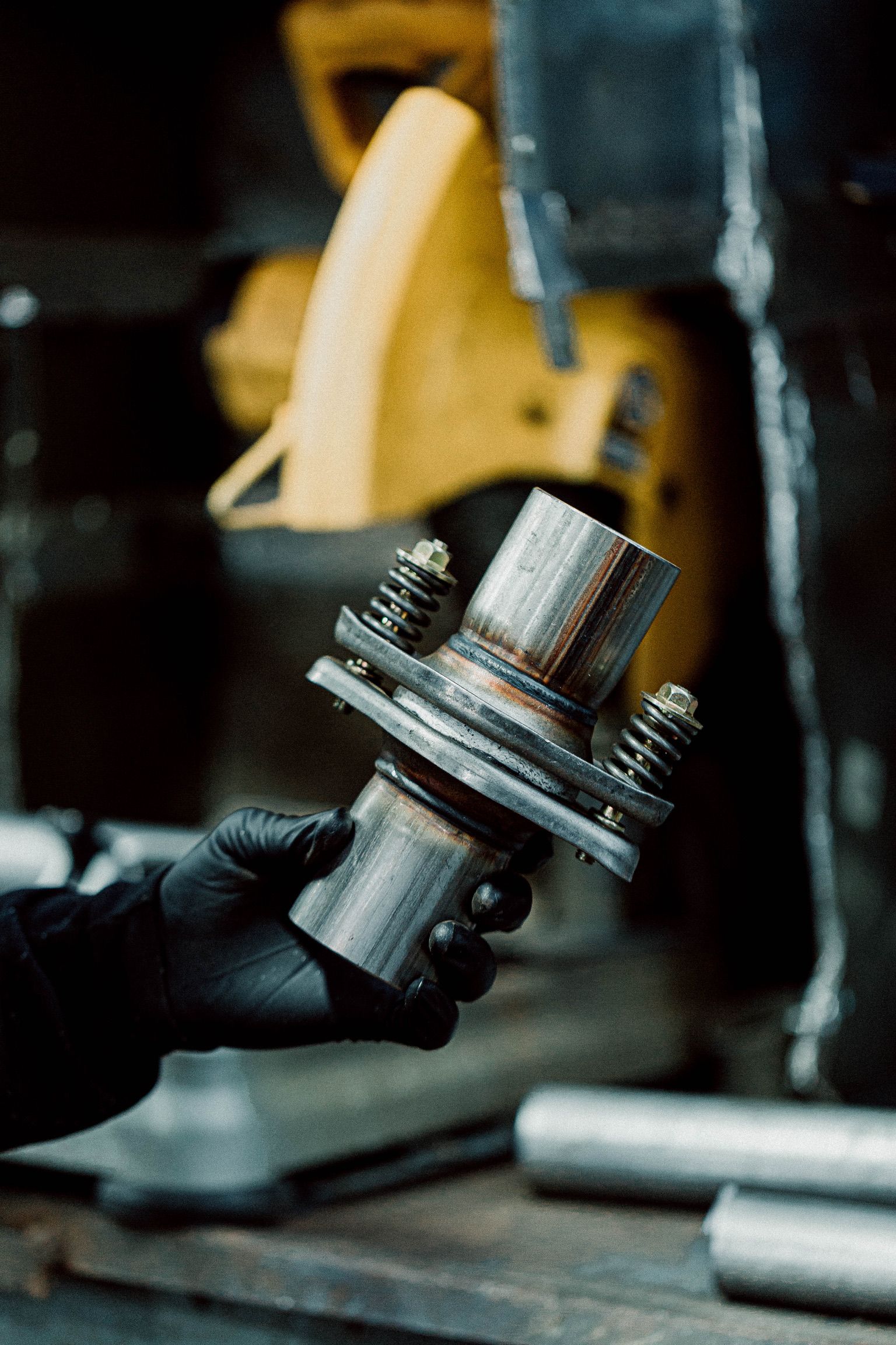 A person is holding a piece of metal in their hand.