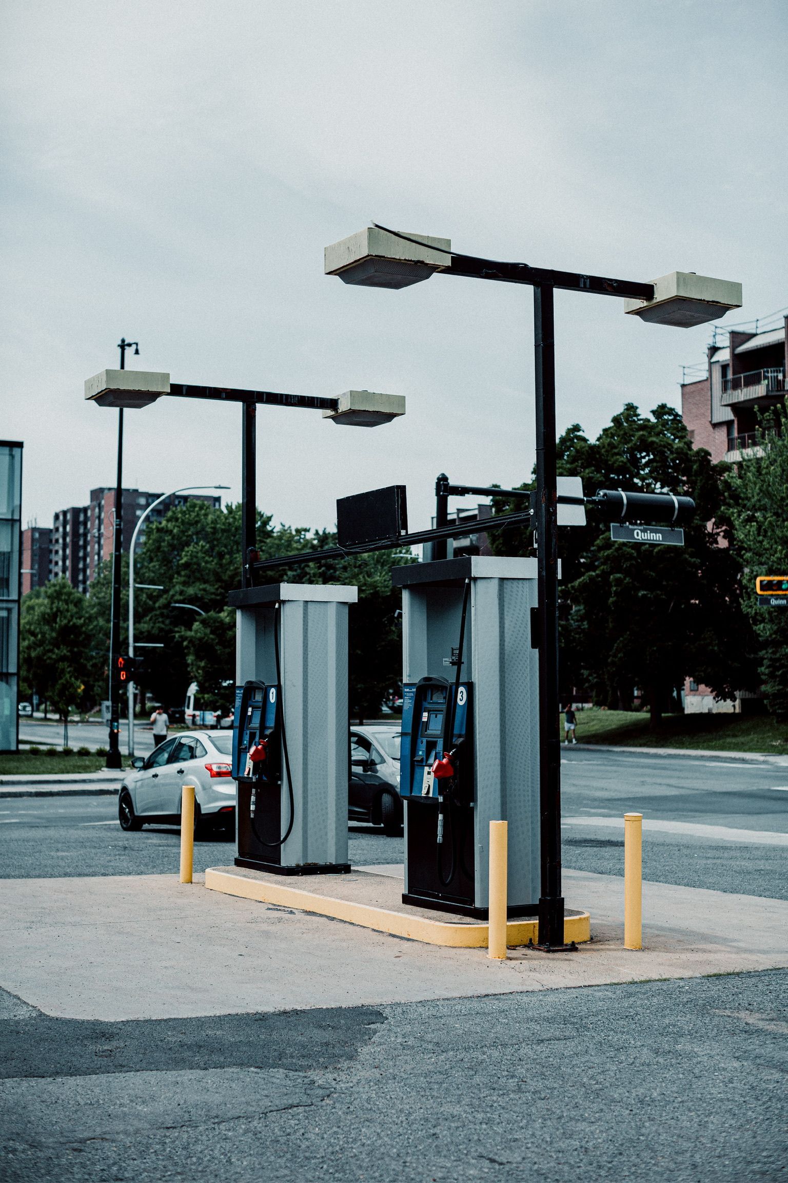 A row of gas pumps on the side of the road