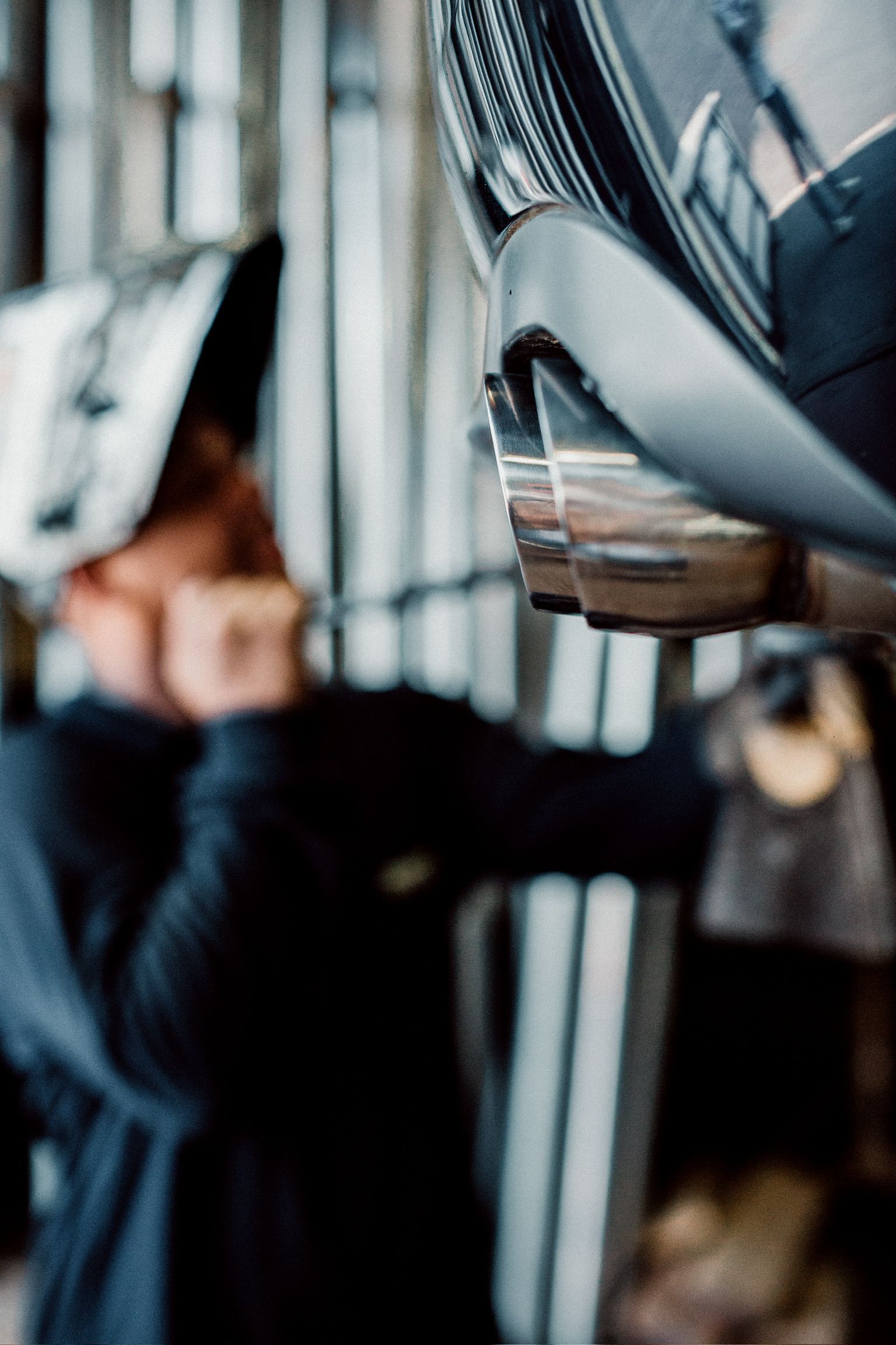 A woman is looking at a pair of shoes hanging on a rack.