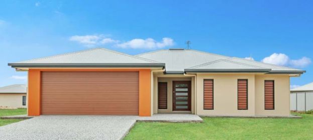 A House With an Orange Garage Door and a Blue Sky in the Background — Ashlee Jones Homes in Gordonvale, QLD