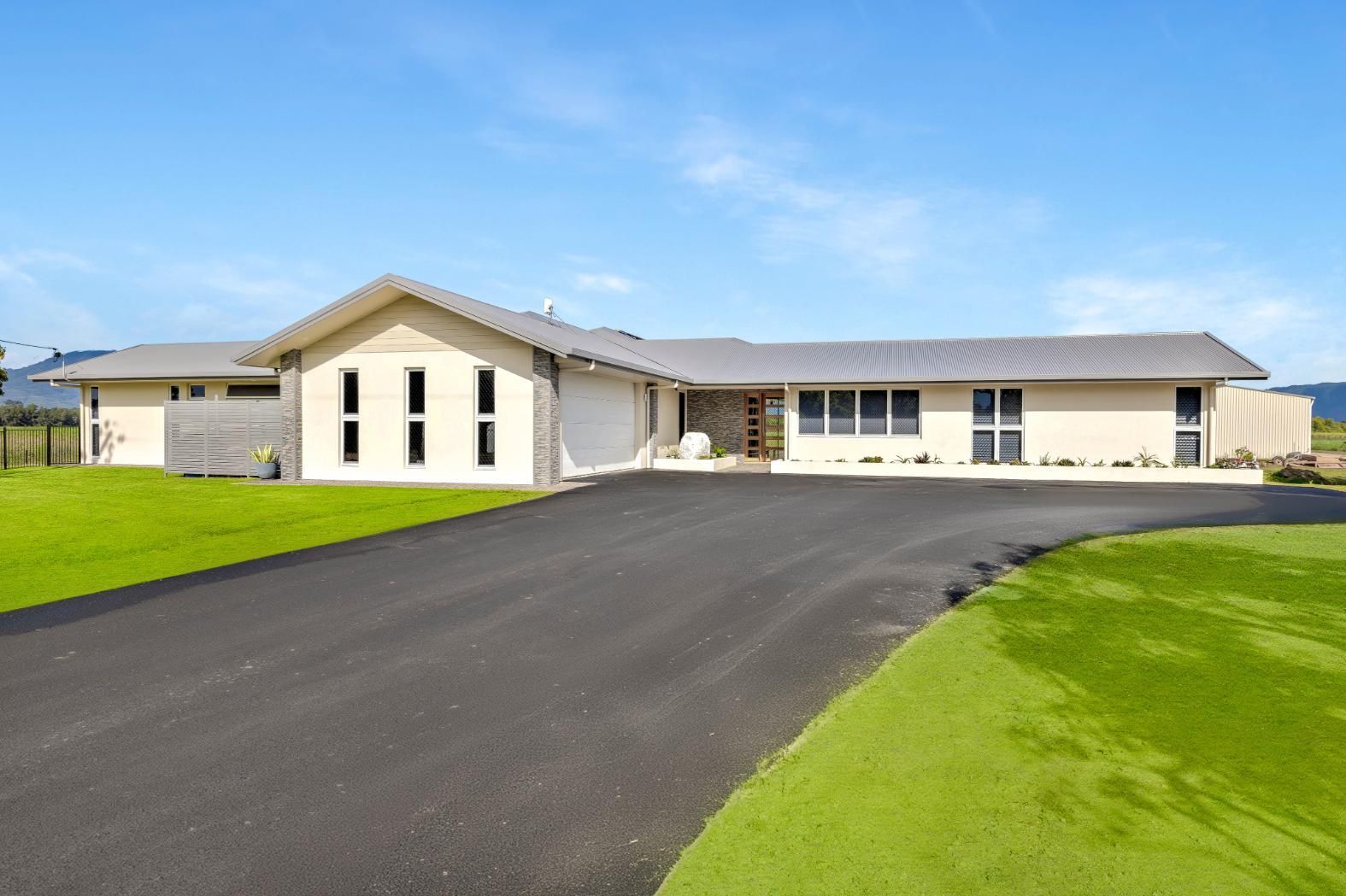 A Large House With a Driveway Leading to It is for Sale — Ashlee Jones Homes in Gordonvale, QLD
