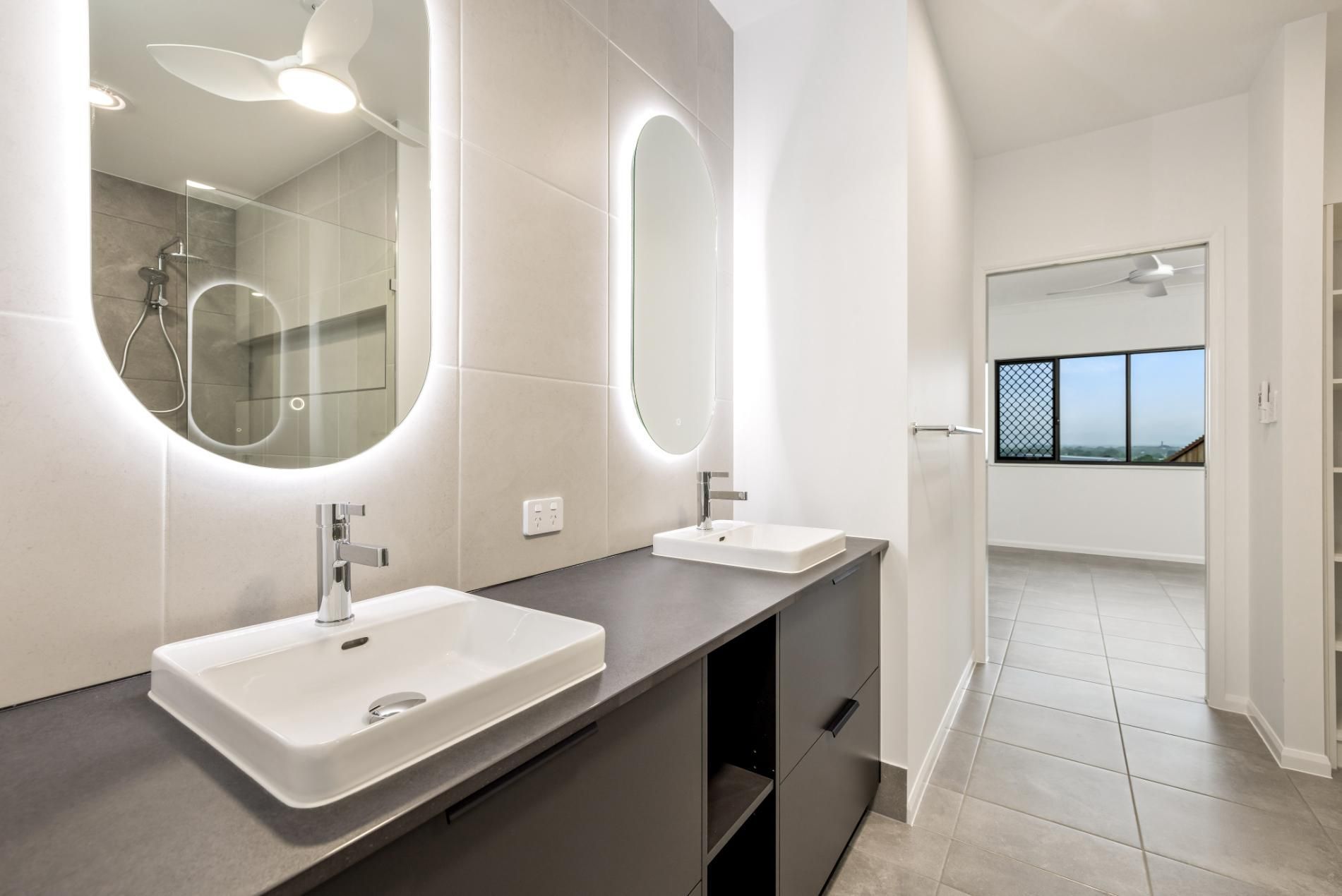 A Bathroom With Two Sinks and Two Mirrors — Ashlee Jones Homes in Gordonvale, QLD