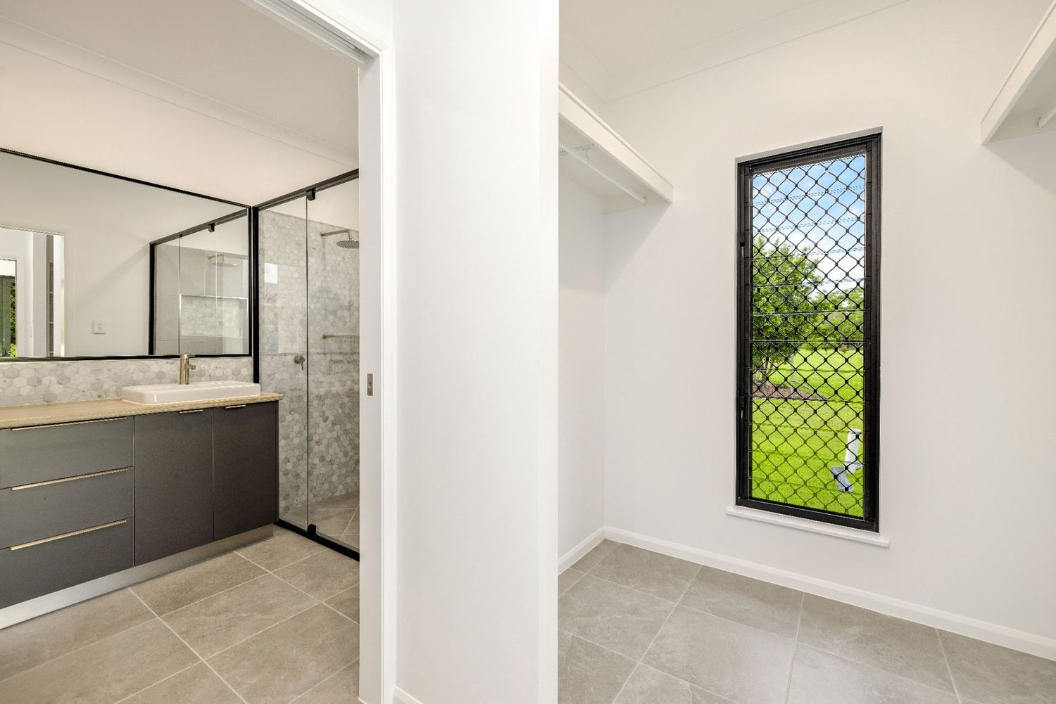 A Bathroom With a Sink and a Window Next to a Bedroom — Ashlee Jones Homes in Gordonvale, QLD