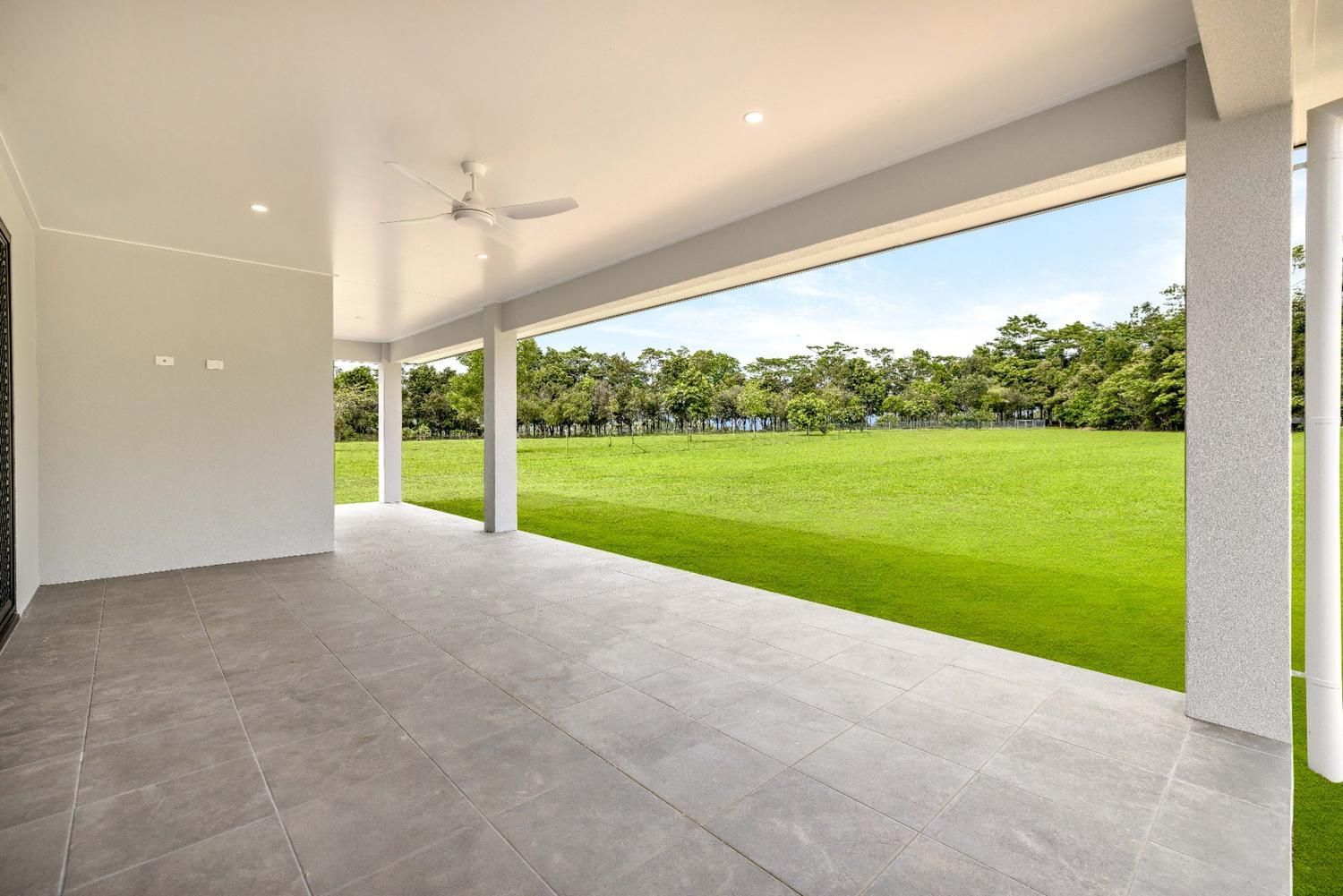An Empty Patio With a View of a Grassy Field — Ashlee Jones Homes in Gordonvale, QLD