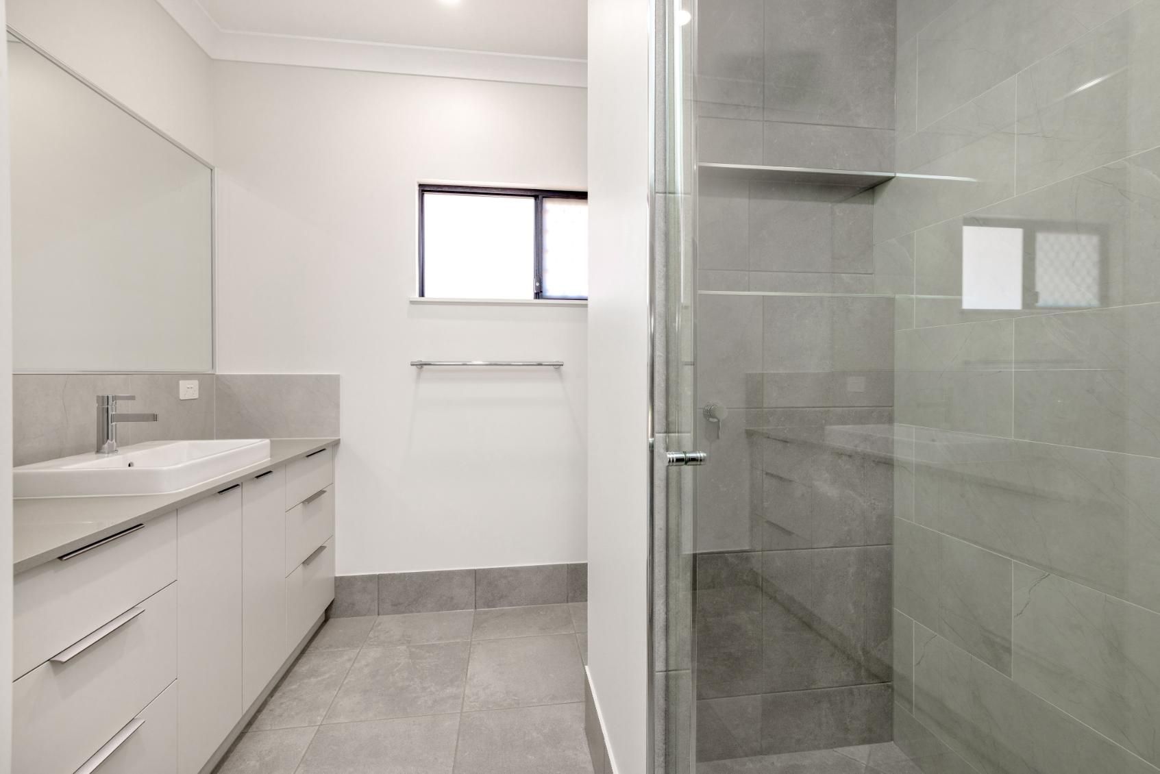 A Bathroom With a Sink and a Walk in Shower — Ashlee Jones Homes in Gordonvale, QLD