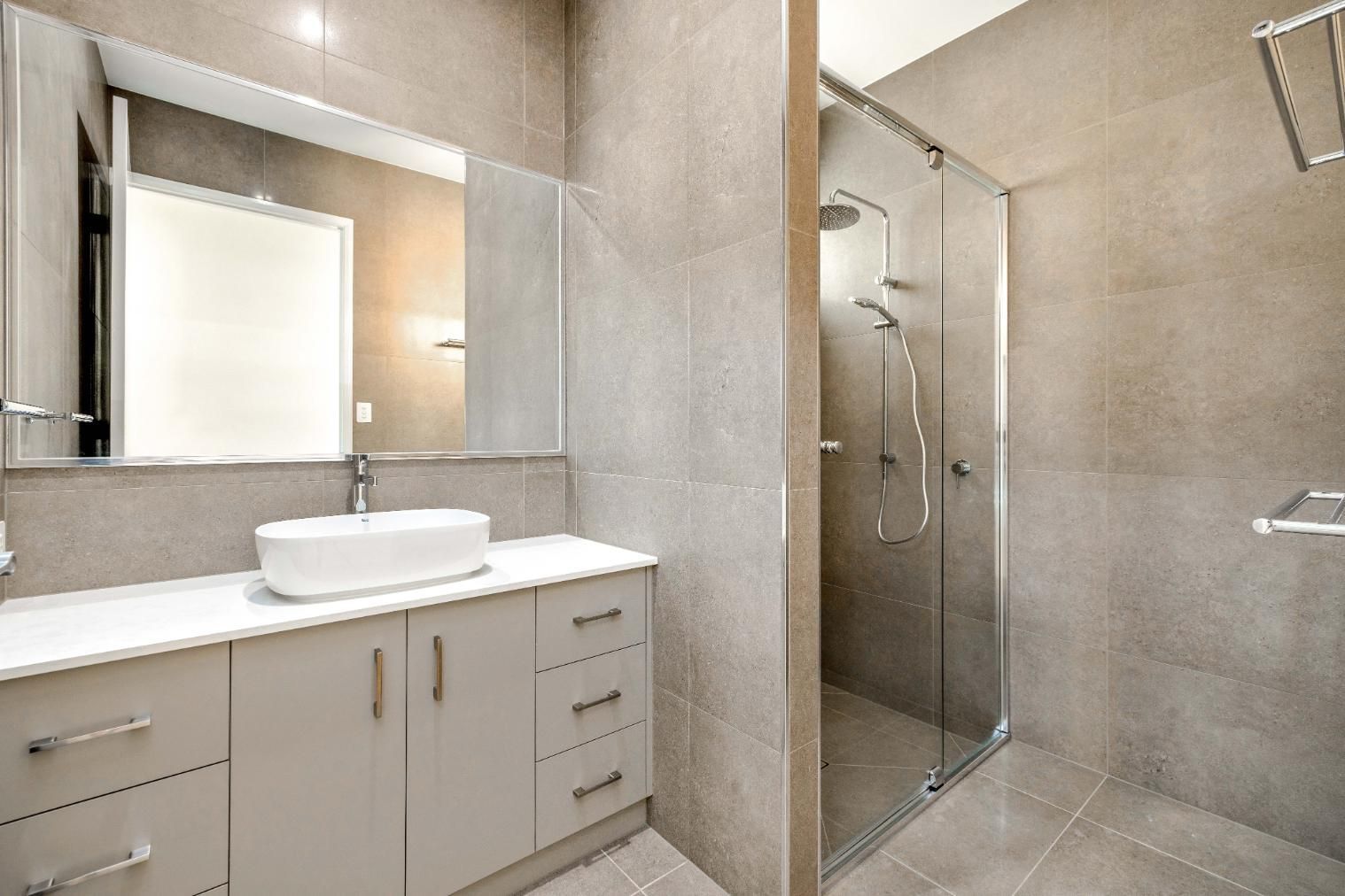 A Bathroom With a Sink and a Walk in Shower — Ashlee Jones Homes in Gordonvale, QLD