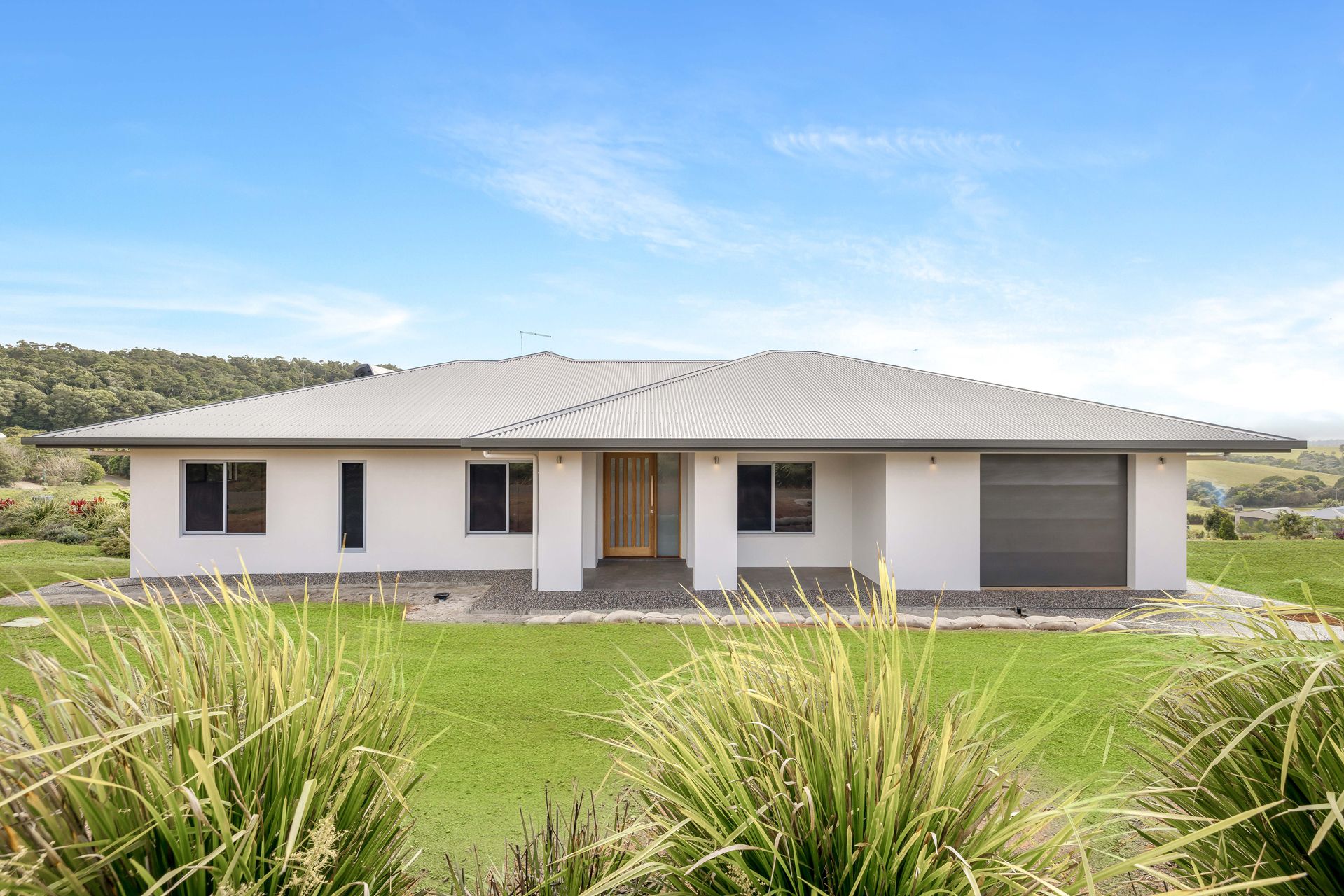 A Modern, Light-colored Single-story House With a Grey Tiled Roof — Ashlee Jones Homes in Gordonvale, QLD