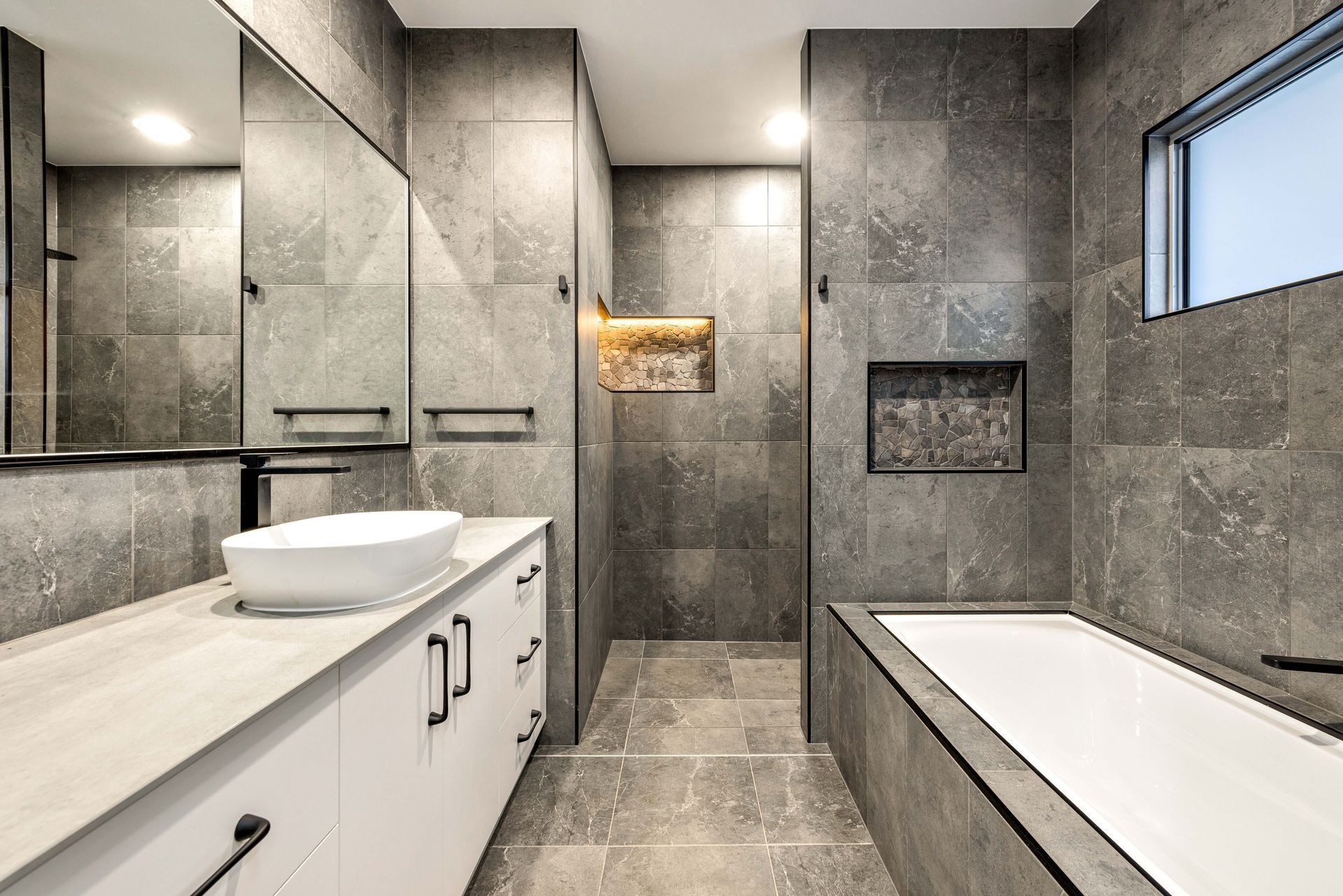 A Kitchen With Stools And A Ceiling Fan — Ashlee Jones Homes in Gordonvale, QLD