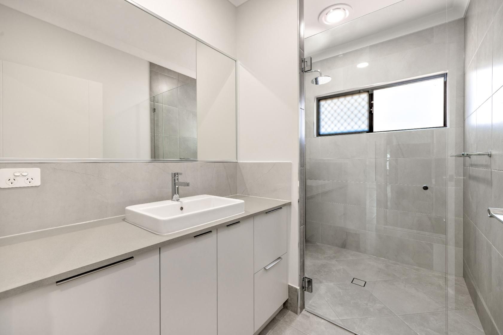 A Bathroom With a Sink and a Walk in Shower — Ashlee Jones Homes in Gordonvale, QLD