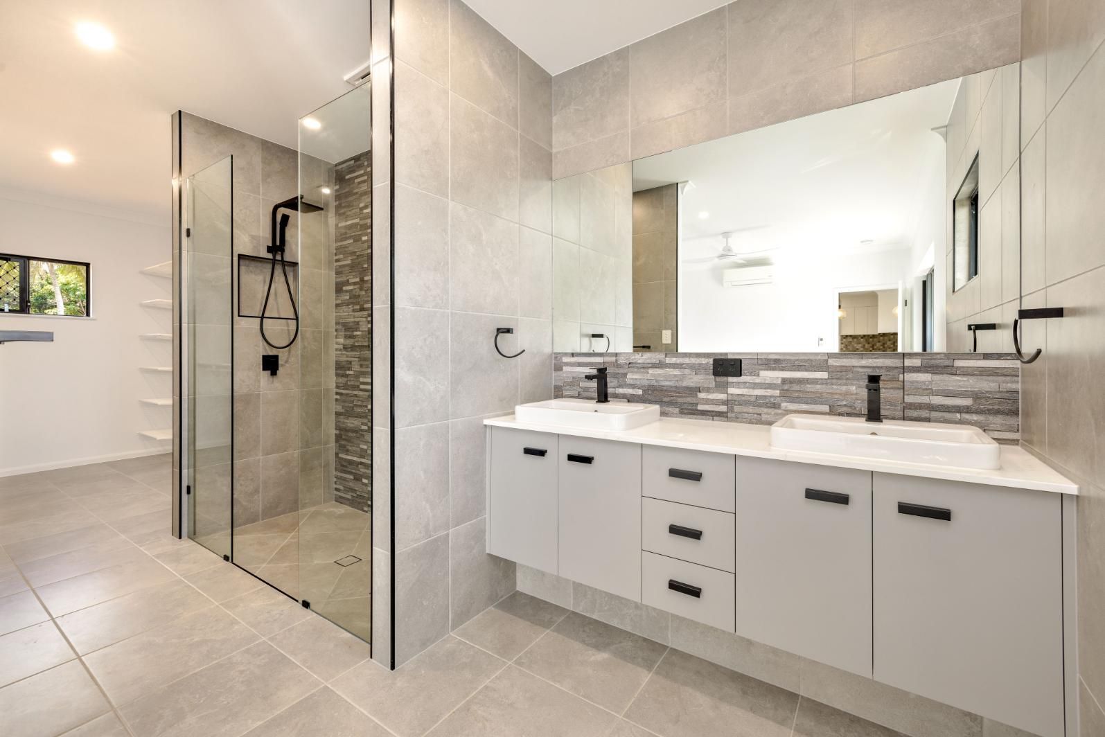 A Bathroom With Two Sinks and a Walk in Shower — Ashlee Jones Homes in Gordonvale, QLD