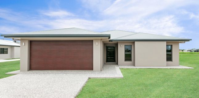 A House With A Garage Door And A Driveway In Front Of It — Ashlee Jones Homes in Gordonvale, QLD