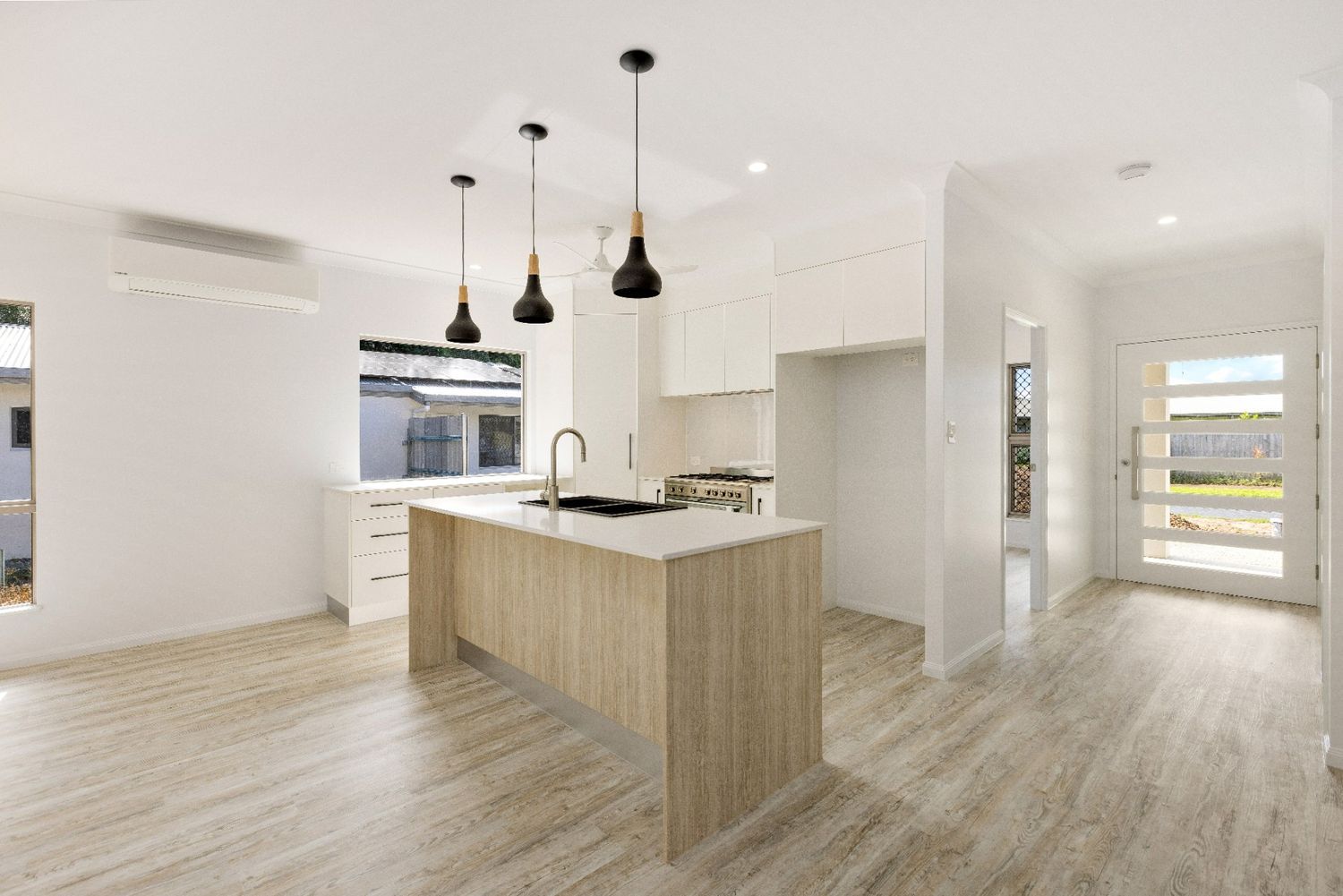 A Kitchen With a Large Island in the Middle of the Room — Ashlee Jones Homes in Gordonvale, QLD