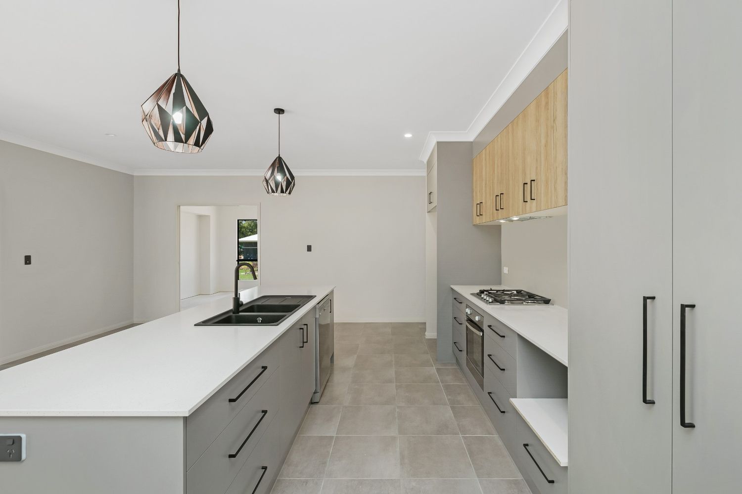 A Kitchen With a Large Island in the Middle of the Room — Ashlee Jones Homes in Gordonvale, QLD