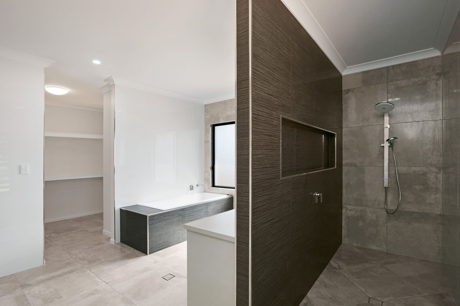 A Bathroom With a Walk in Shower and a Bathtub — Ashlee Jones Homes in Gordonvale, QLD