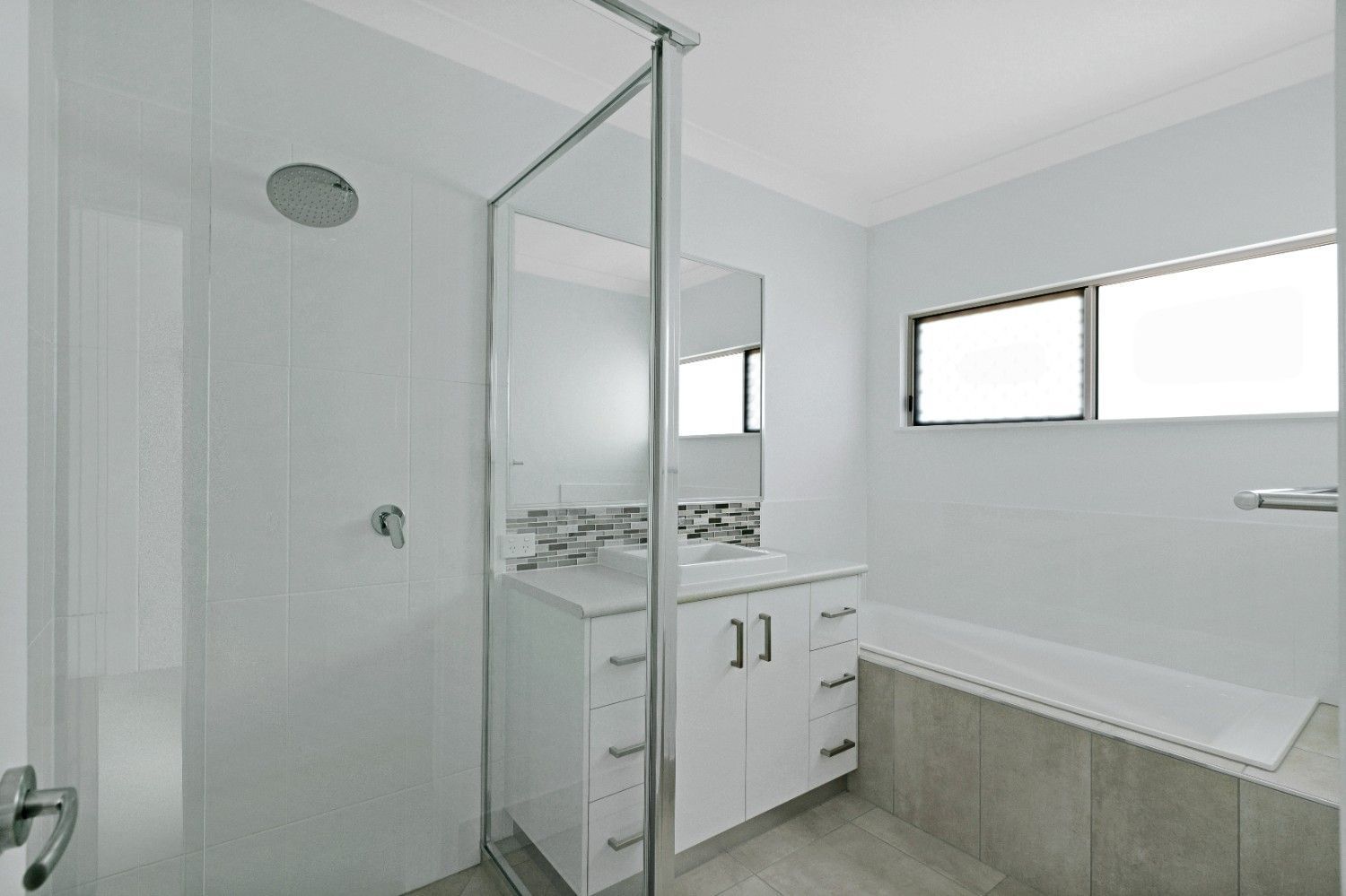 A Bathroom With a Sink, Shower and Bathtub — Ashlee Jones Homes in Gordonvale, QLD