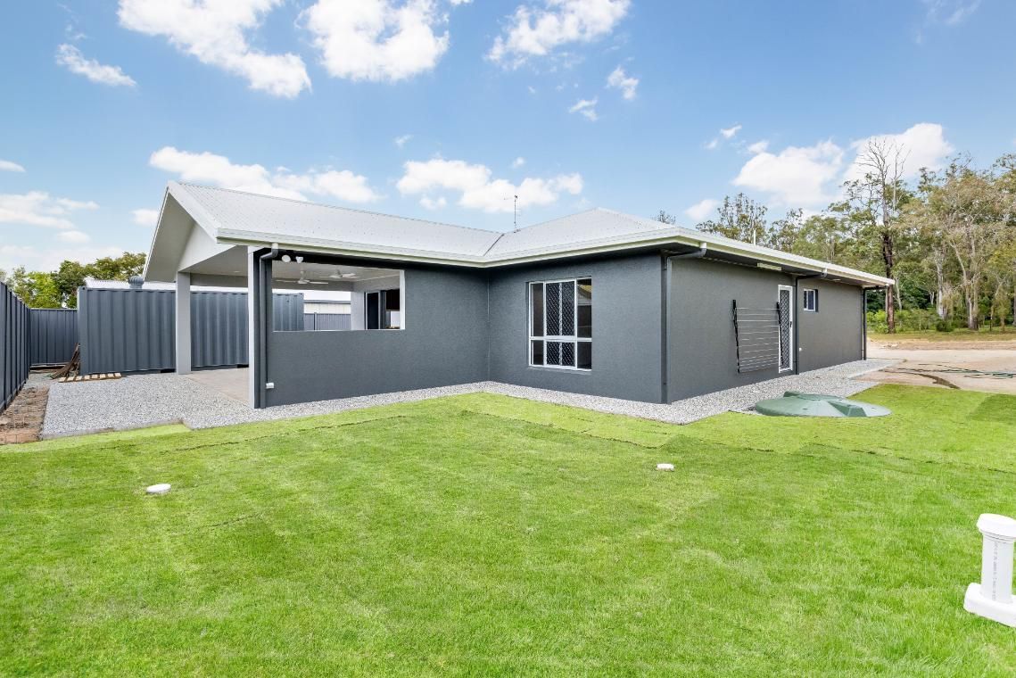 The Back of a House With a Large Lawn in Front of It — Ashlee Jones Homes in Gordonvale, QLD