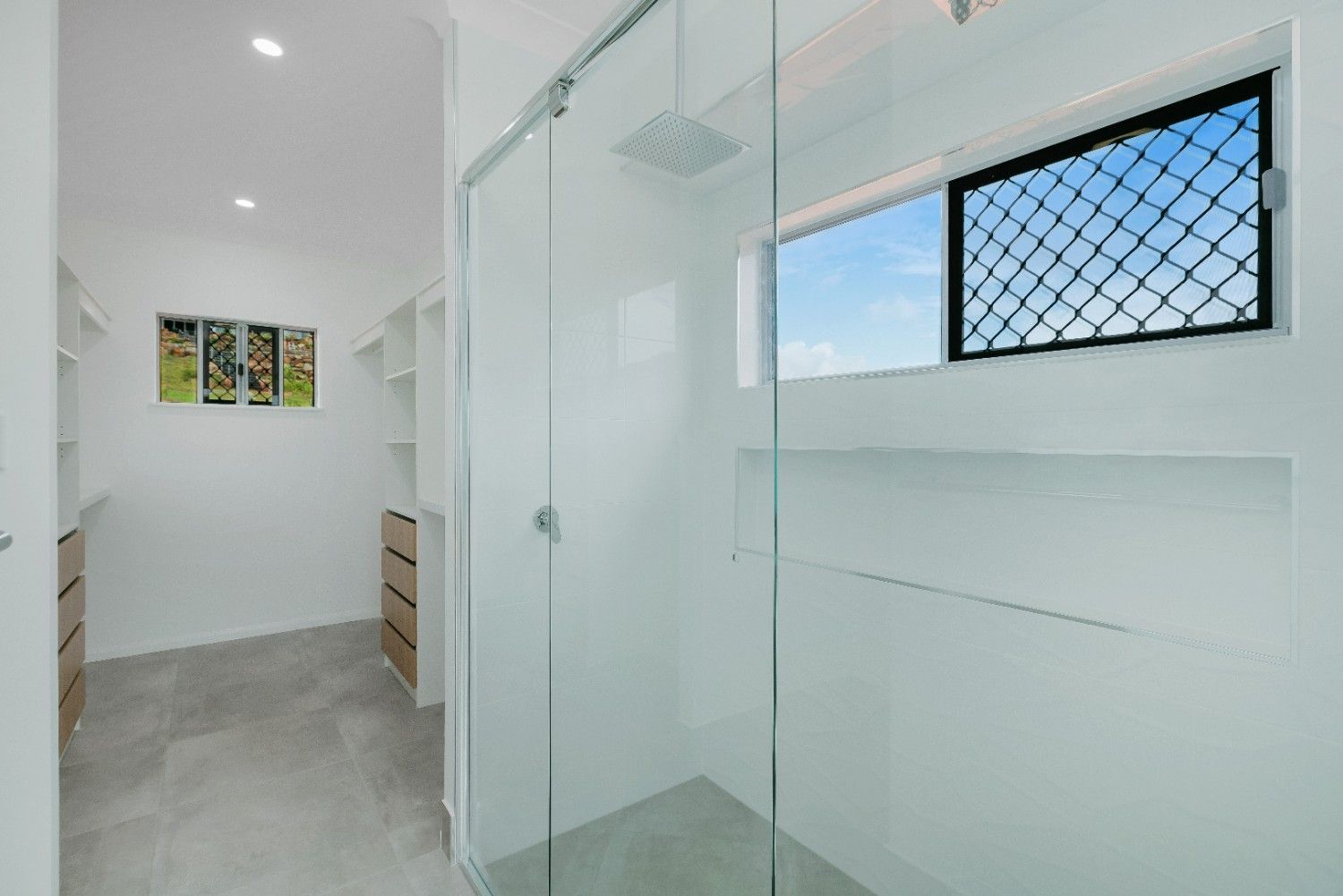 A Walk in Closet With a Shower and a Window — Ashlee Jones Homes in Gordonvale, QLD