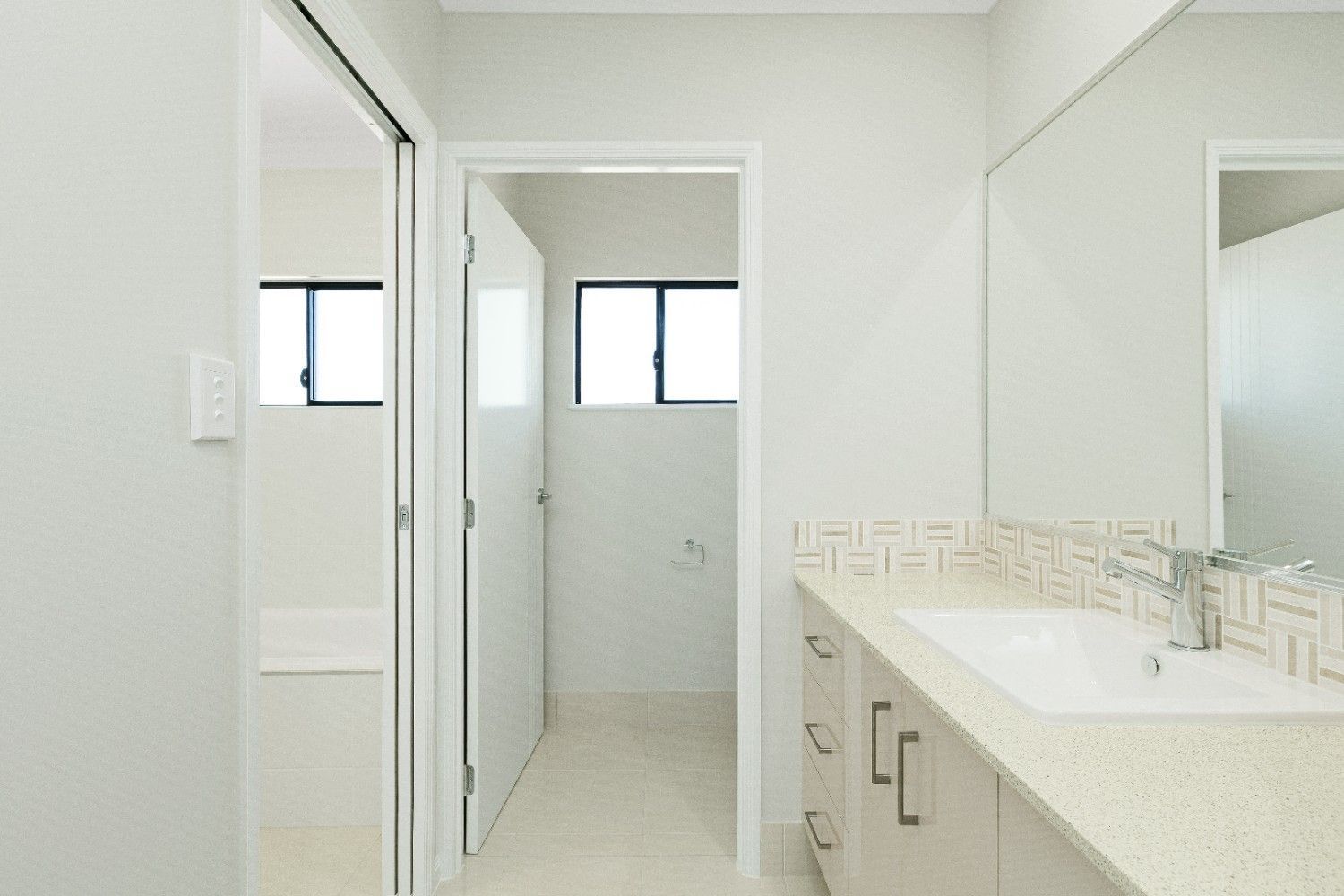 A Bathroom With a Sink and a Mirror — Ashlee Jones Homes in Gordonvale, QLD