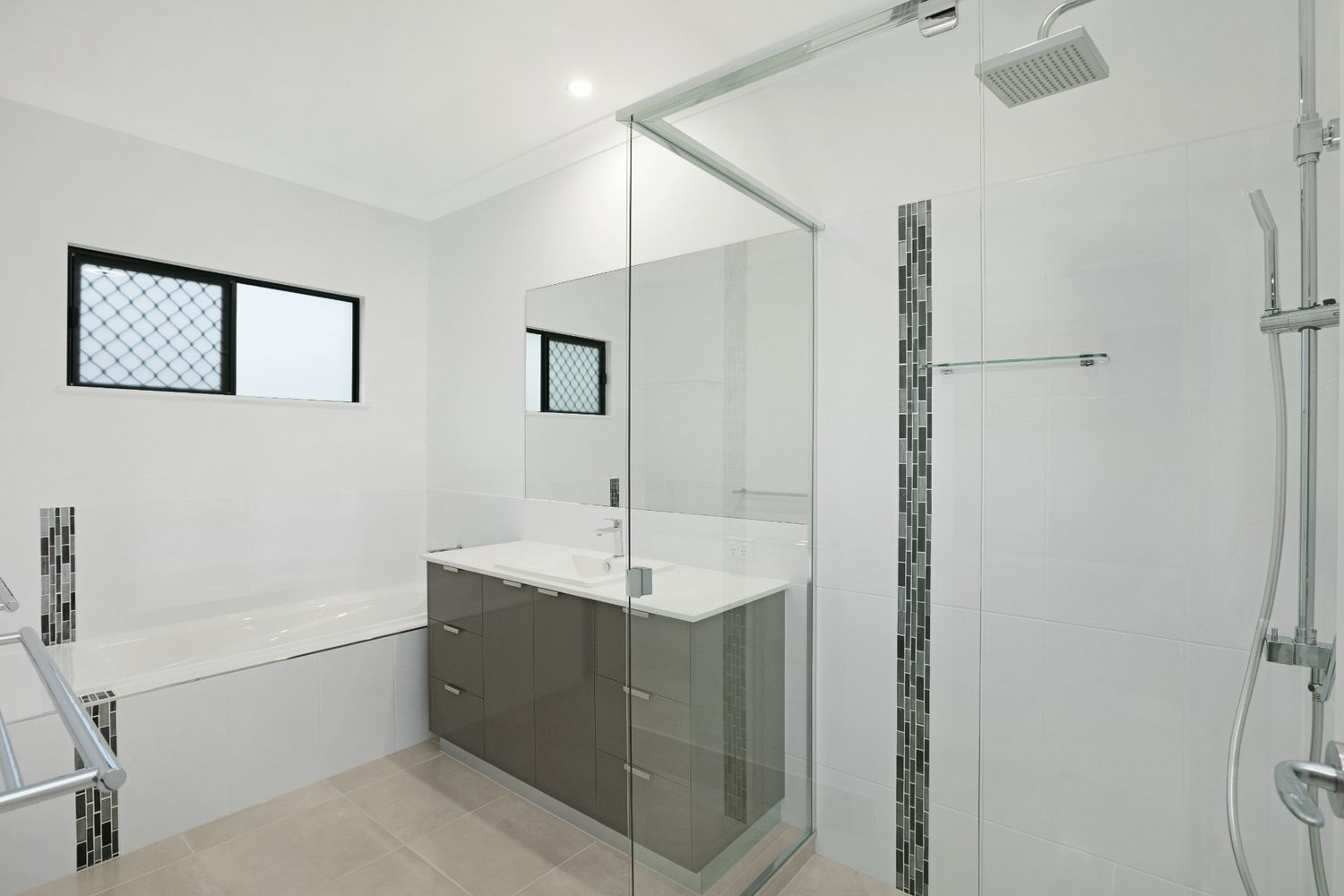 A Bathroom With a Walk in Shower and a Sink — Ashlee Jones Homes in Gordonvale, QLD