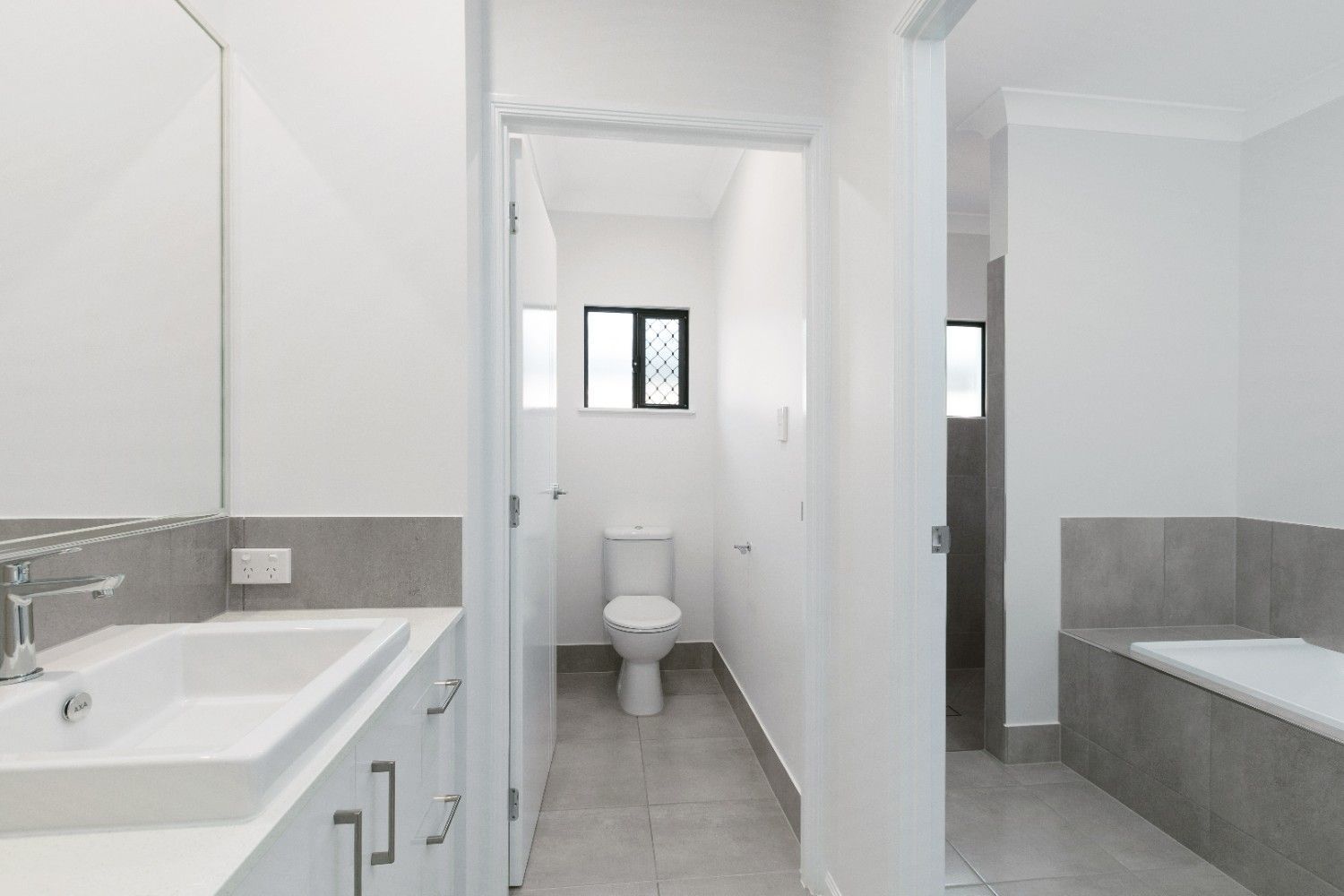 A Bathroom With a Toilet a Sink and a Bathtub — Ashlee Jones Homes in Gordonvale, QLD