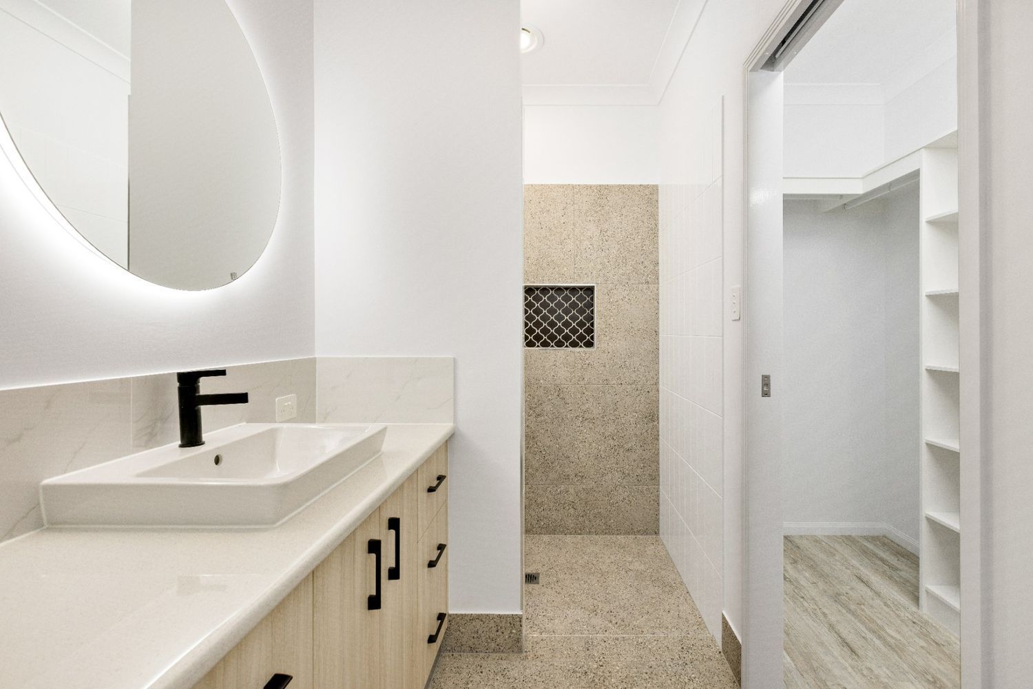 A Bathroom With a Sink, Mirror and Walk in Shower — Ashlee Jones Homes in Gordonvale, QLD