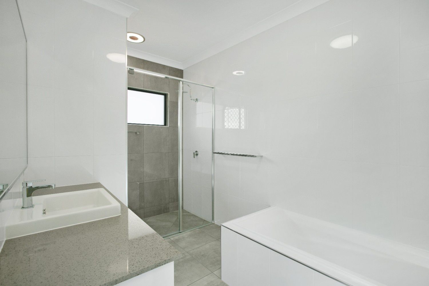 A Bathroom With a Sink, Tub and Shower — Ashlee Jones Homes in Gordonvale, QLD