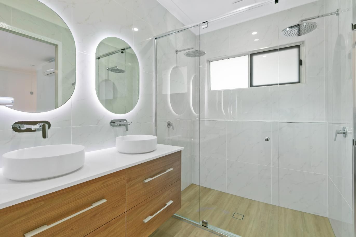 A Bathroom With Two Sinks and a Walk in Shower — Ashlee Jones Homes in Gordonvale, QLD