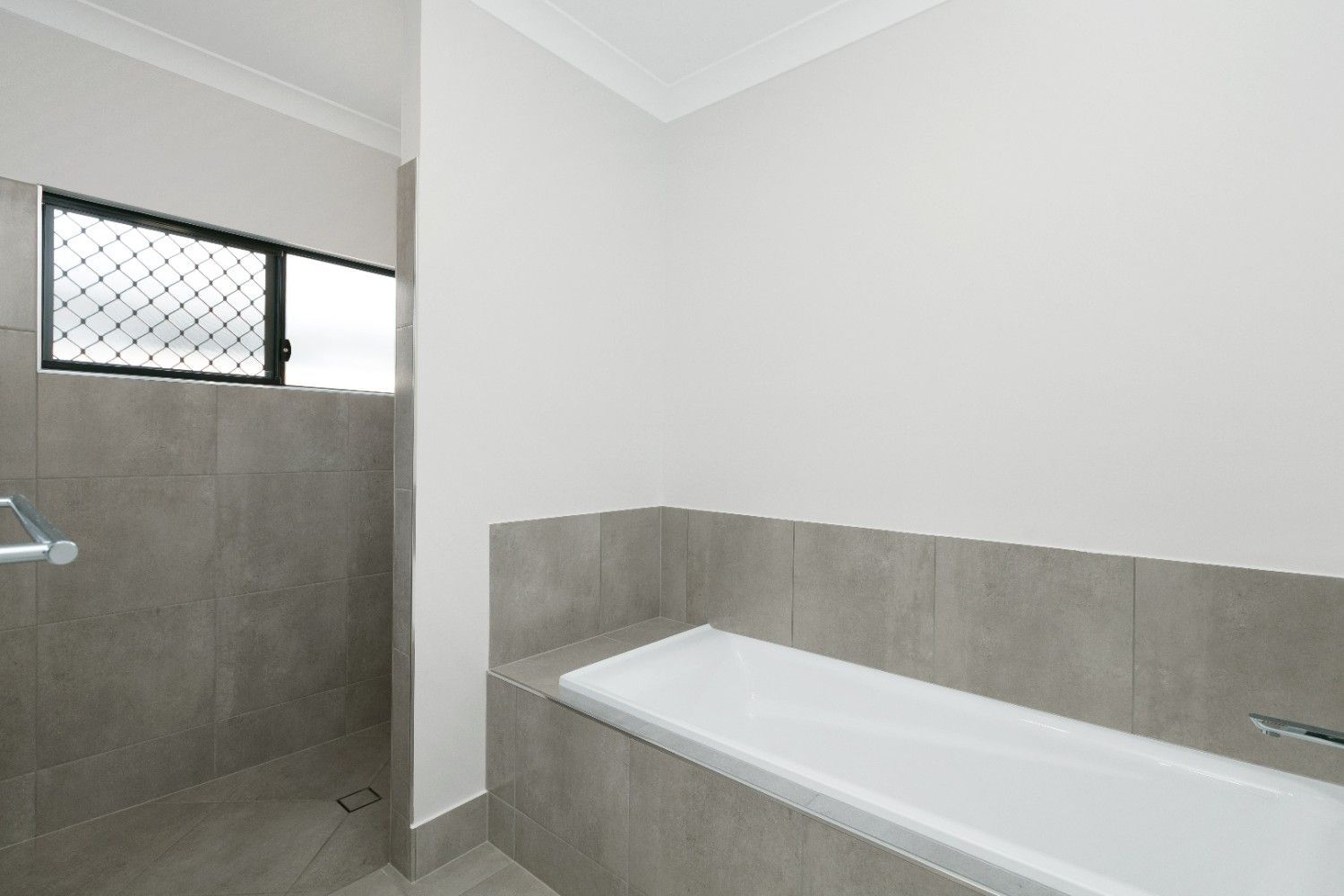 A Bathroom With a Bathtub and a Shower — Ashlee Jones Homes in Gordonvale, QLD