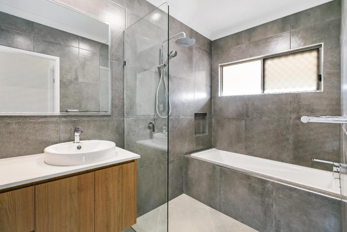 A Bathroom With a Sink, Tub, Shower and Mirror — Ashlee Jones Homes in Gordonvale, QLD