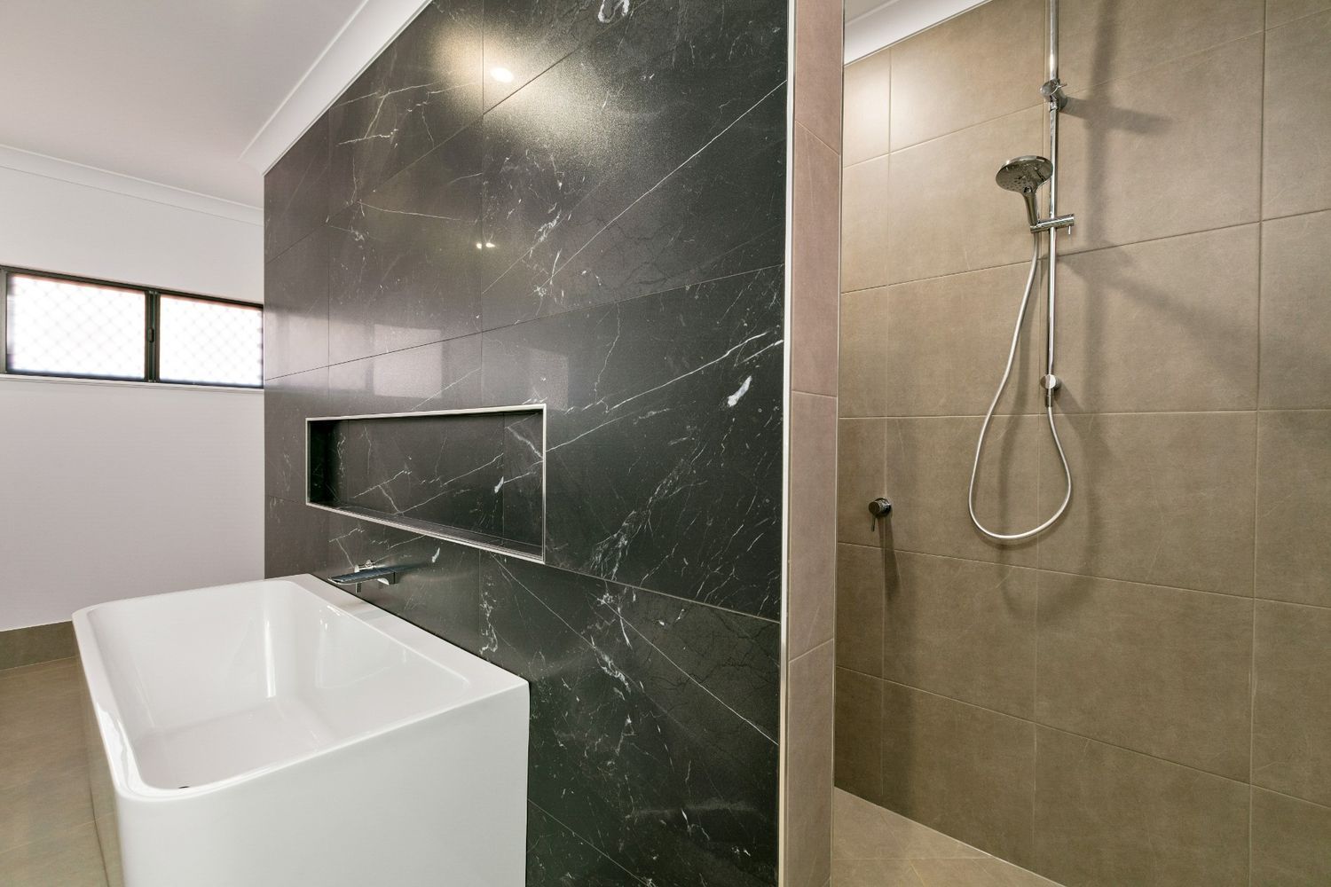 A Bathroom With a Bathtub and a Walk in Shower — Ashlee Jones Homes in Gordonvale, QLD