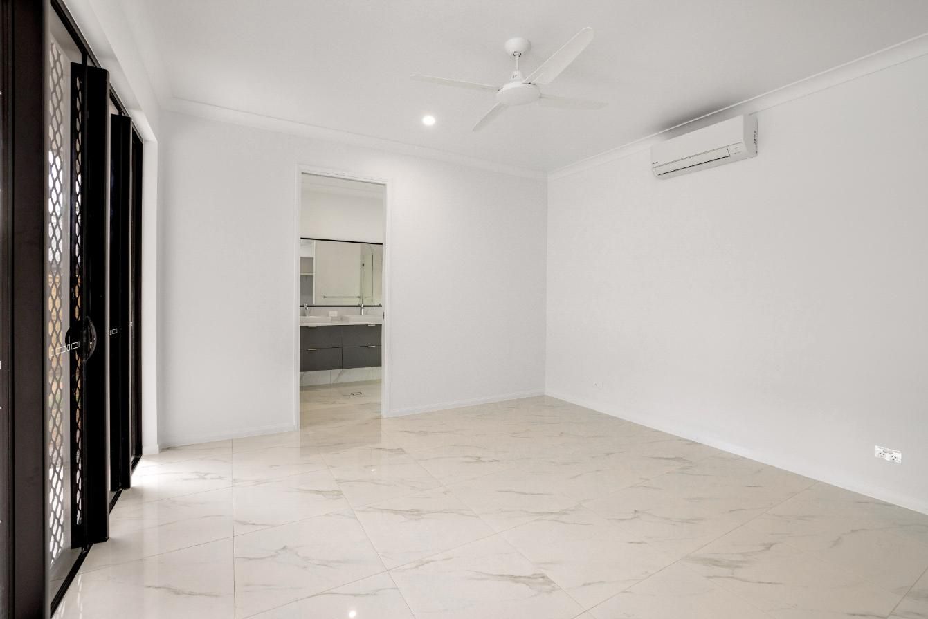 An Empty Room With a Ceiling Fan and a Marble Floor — Ashlee Jones Homes in Gordonvale, QLD